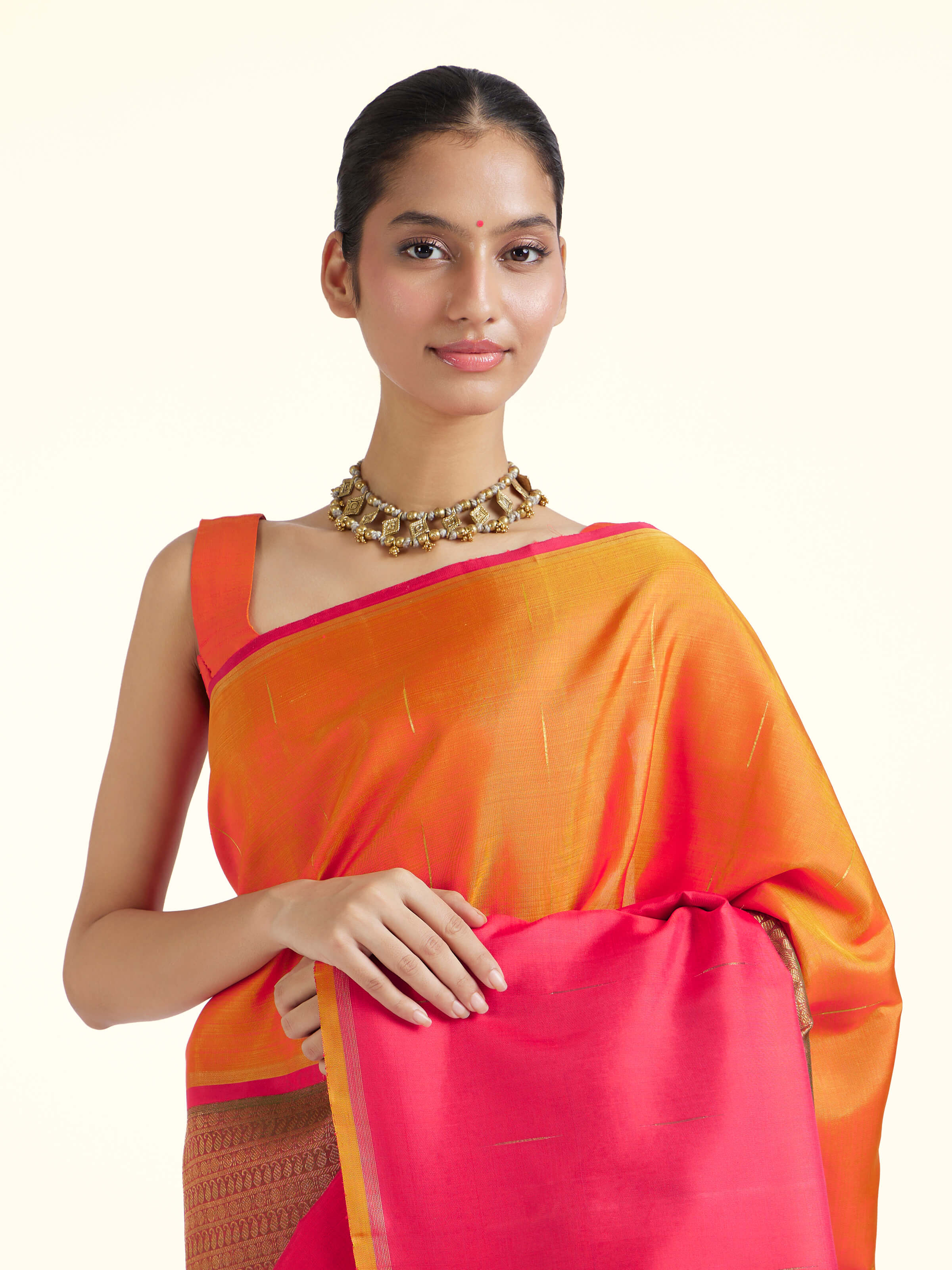 Angled view of red silk Kancheepuram saree highlighting woven motifs