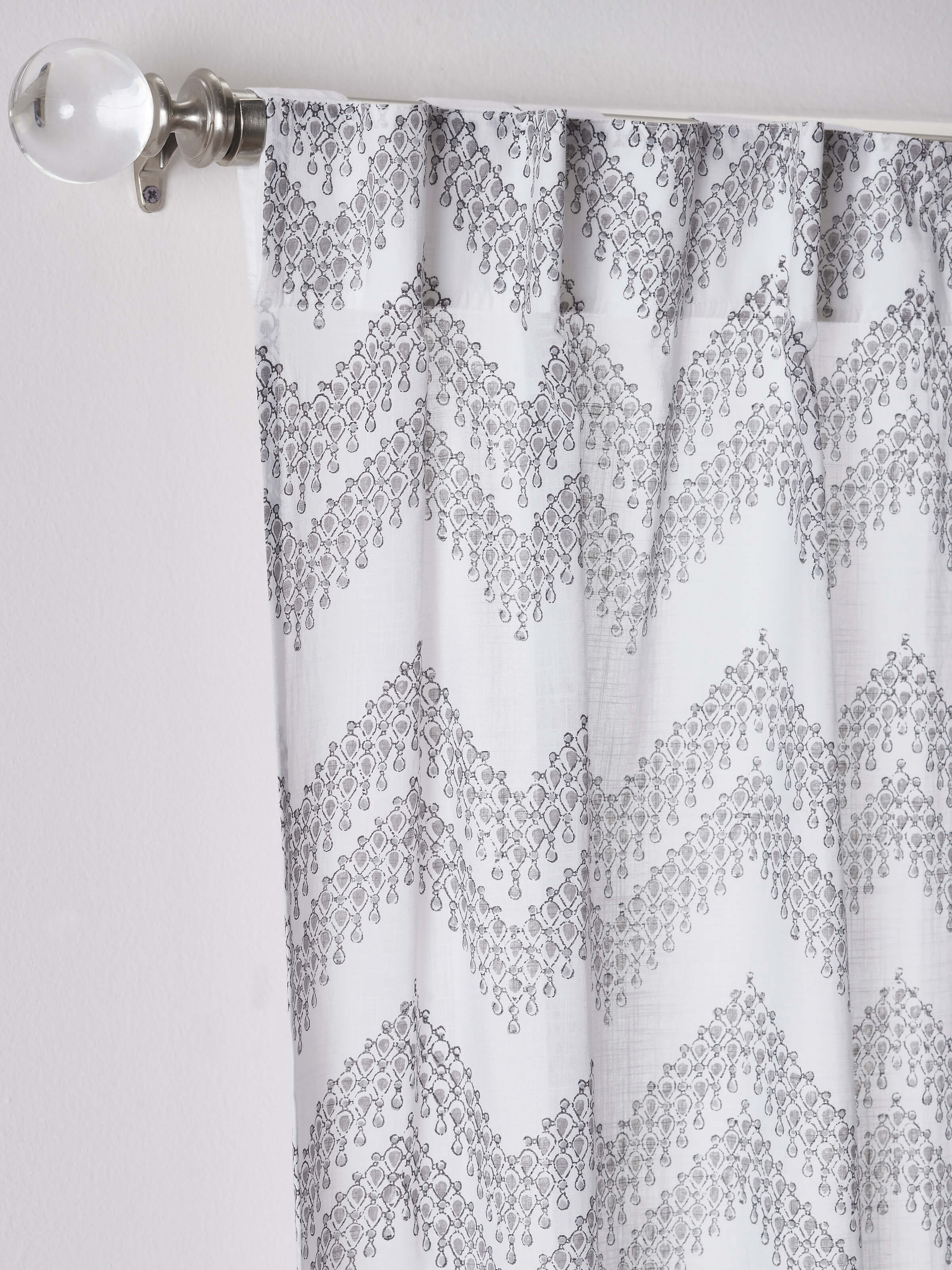 Front view of white cotton curtain with modern geo chevron design and Sanganeri block print.