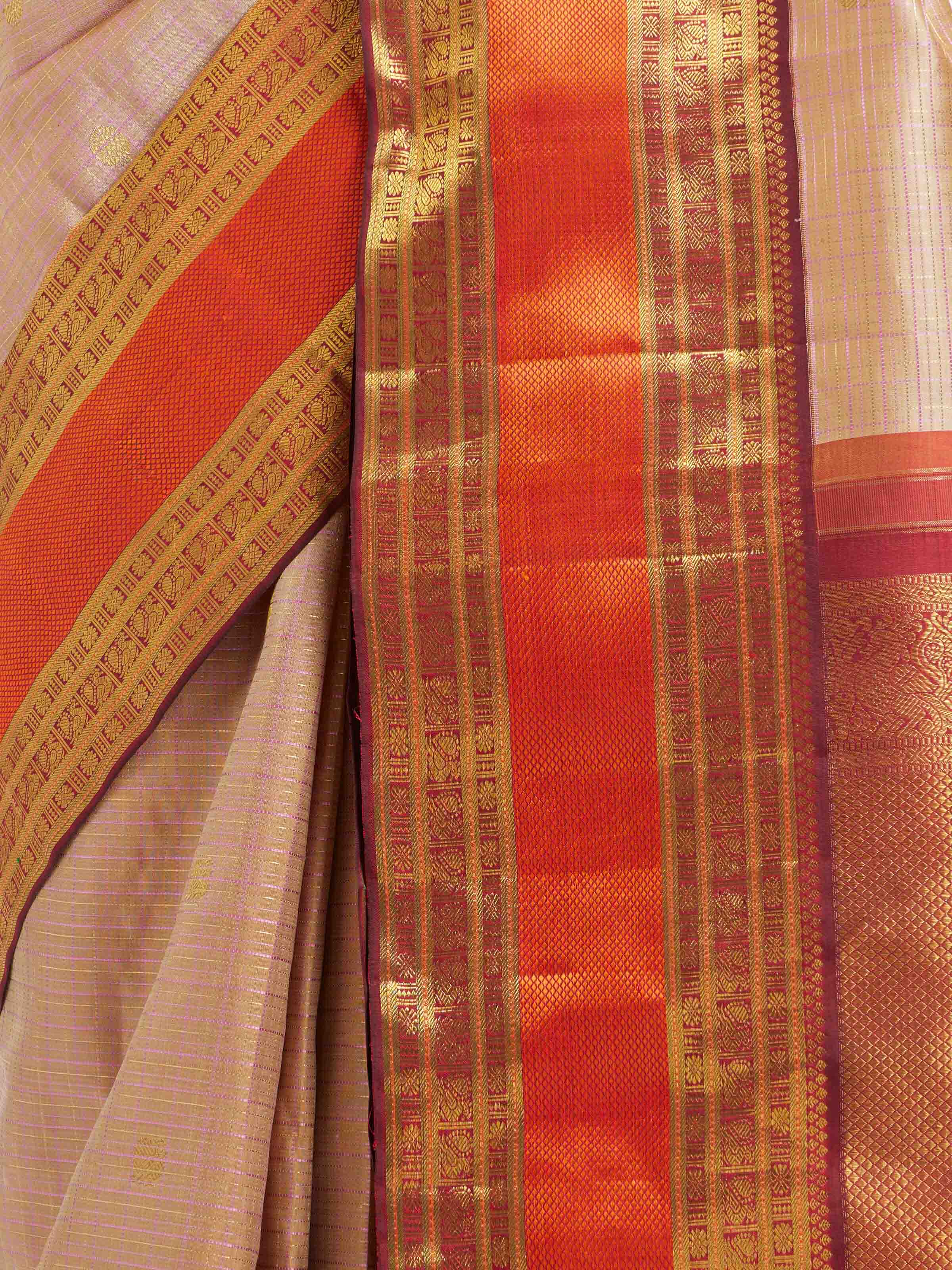 Detail view of biscuit silk Kancheepuram saree showing zari work