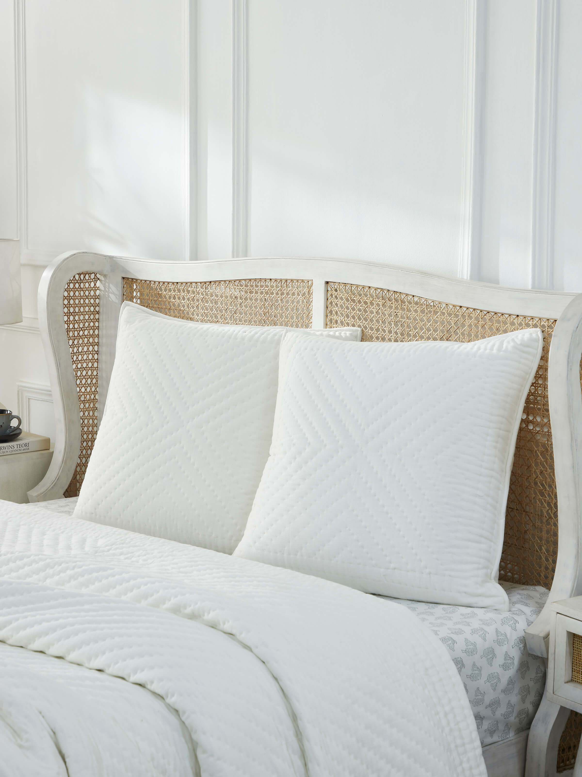 Lifestyle image showcasing Kalpanama Ivory Buti Cotton Euro Shams styled on a bed