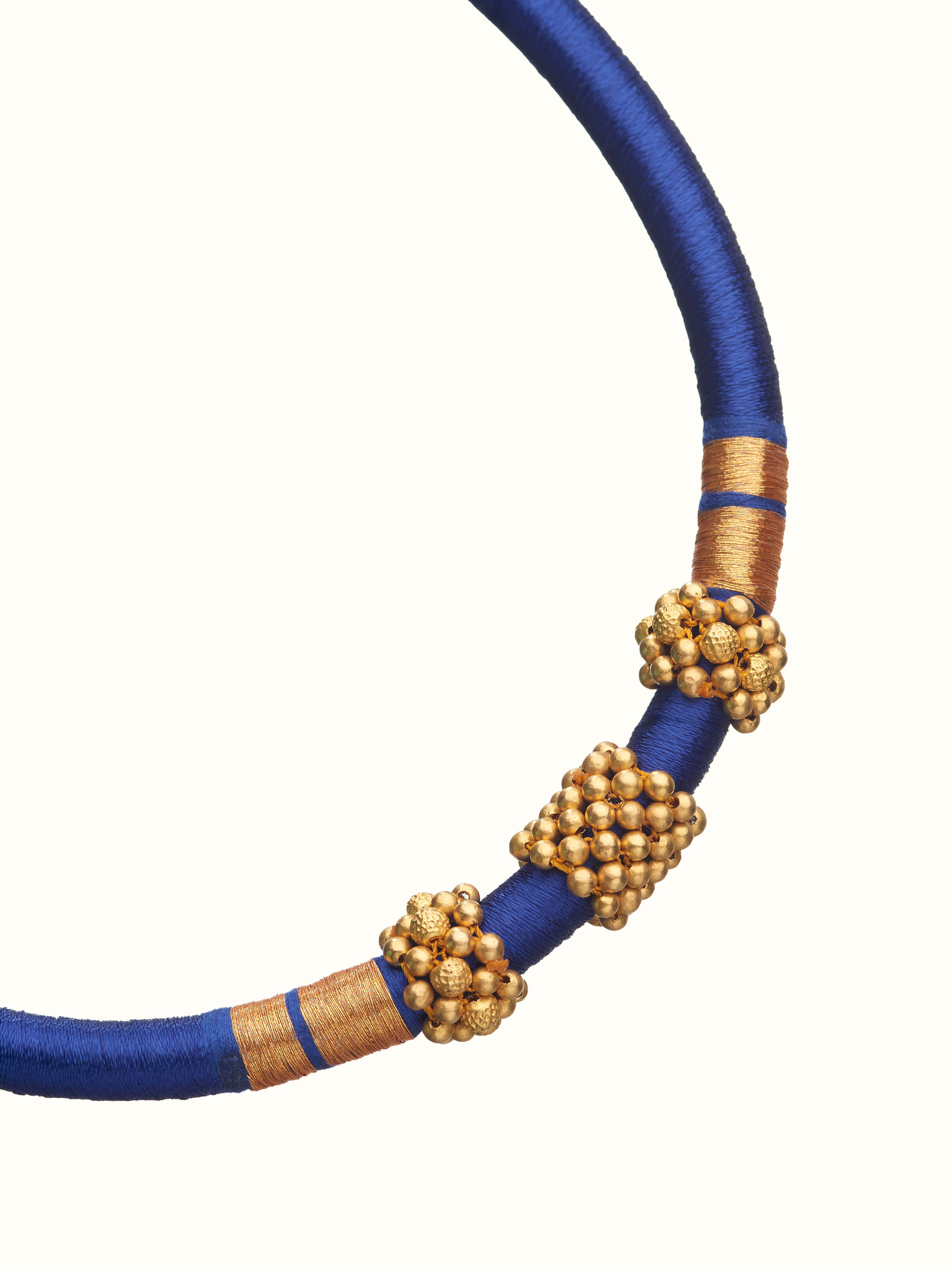 Angled view of Thushi 22 karat gold collar necklace