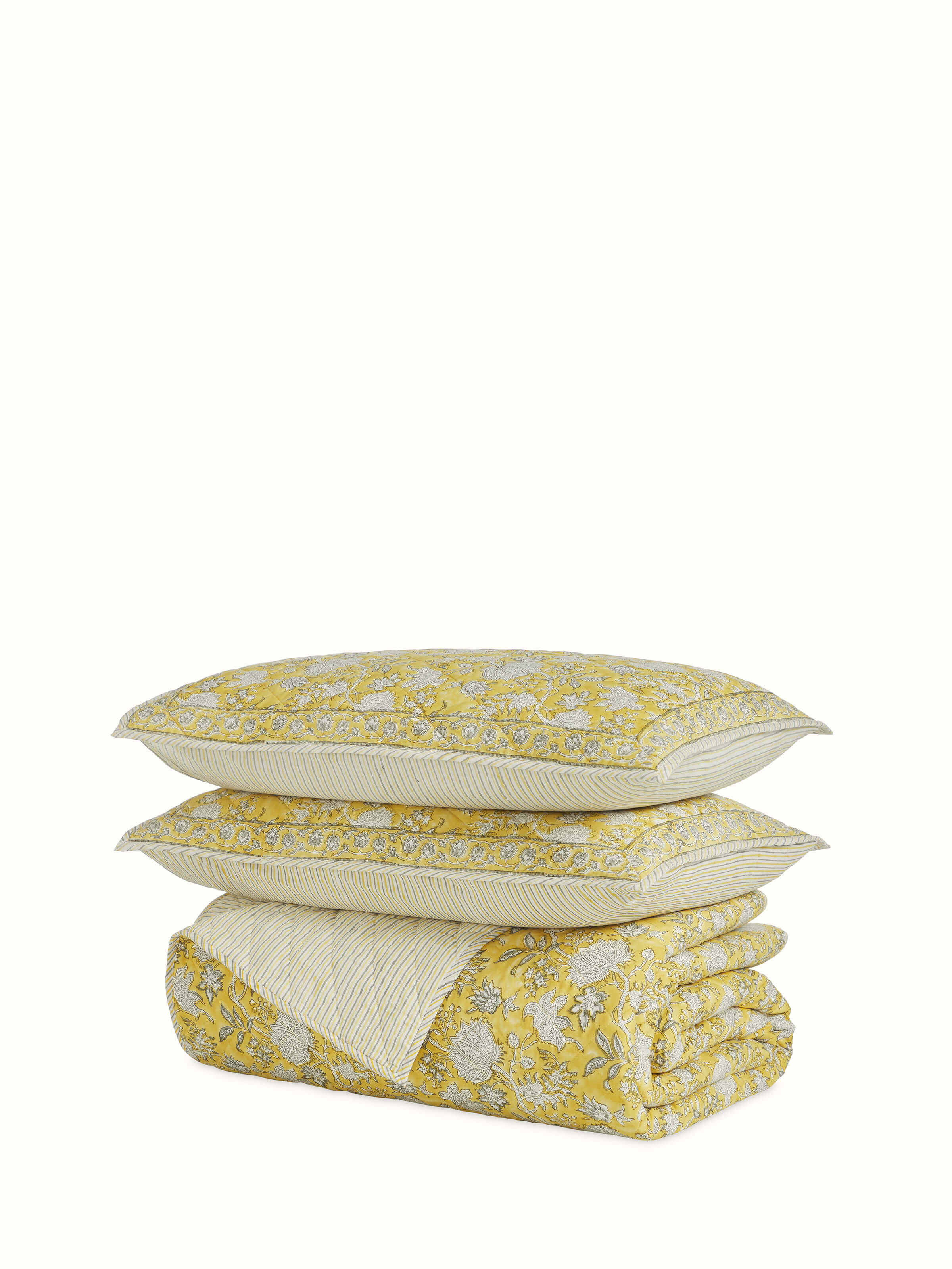 Angled overhead view of Kairavam Yellow Floral Cotton Sanganeri Quilted Bedspread Set, double-size, with traditional hand block floral prints by Swadesh