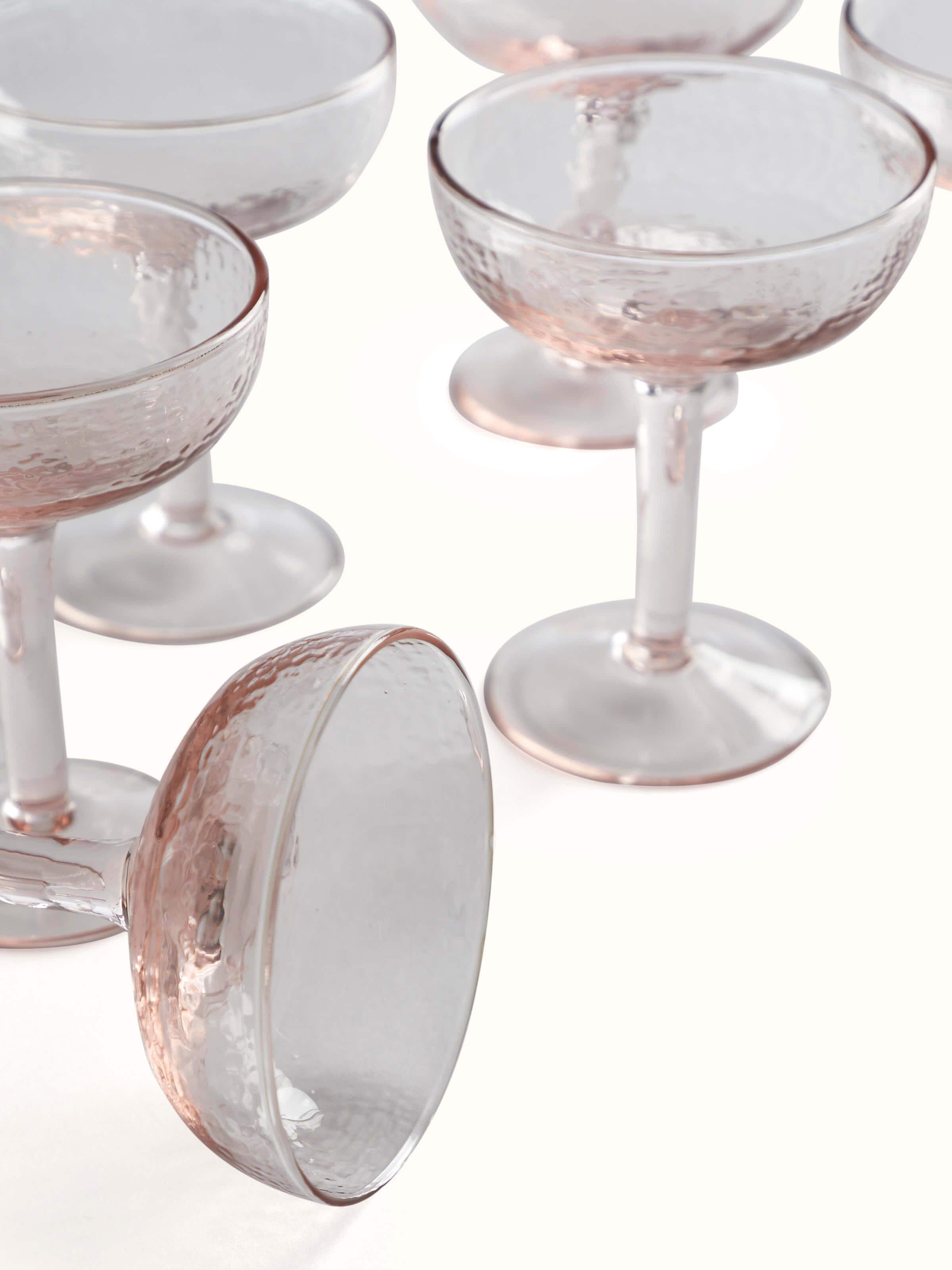 Angle view of Glass-worked Wine Glasses in pink highlighting the glasses' contours and design.
