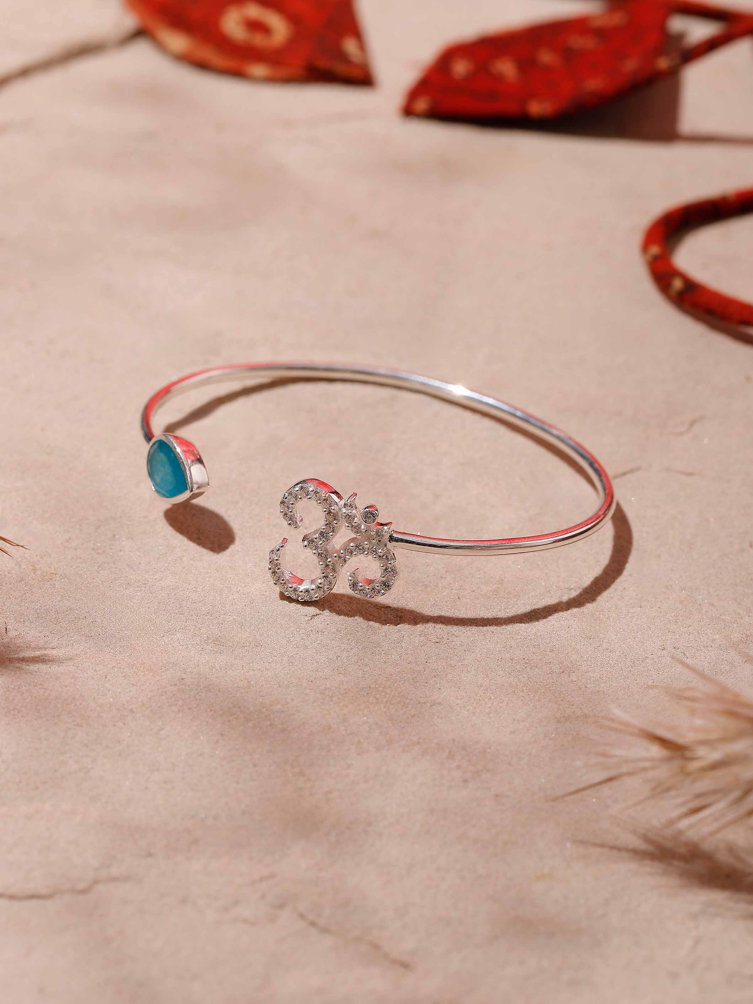 Side view of jade and Om charm bracelet worn casually, highlighting serene green and white hues