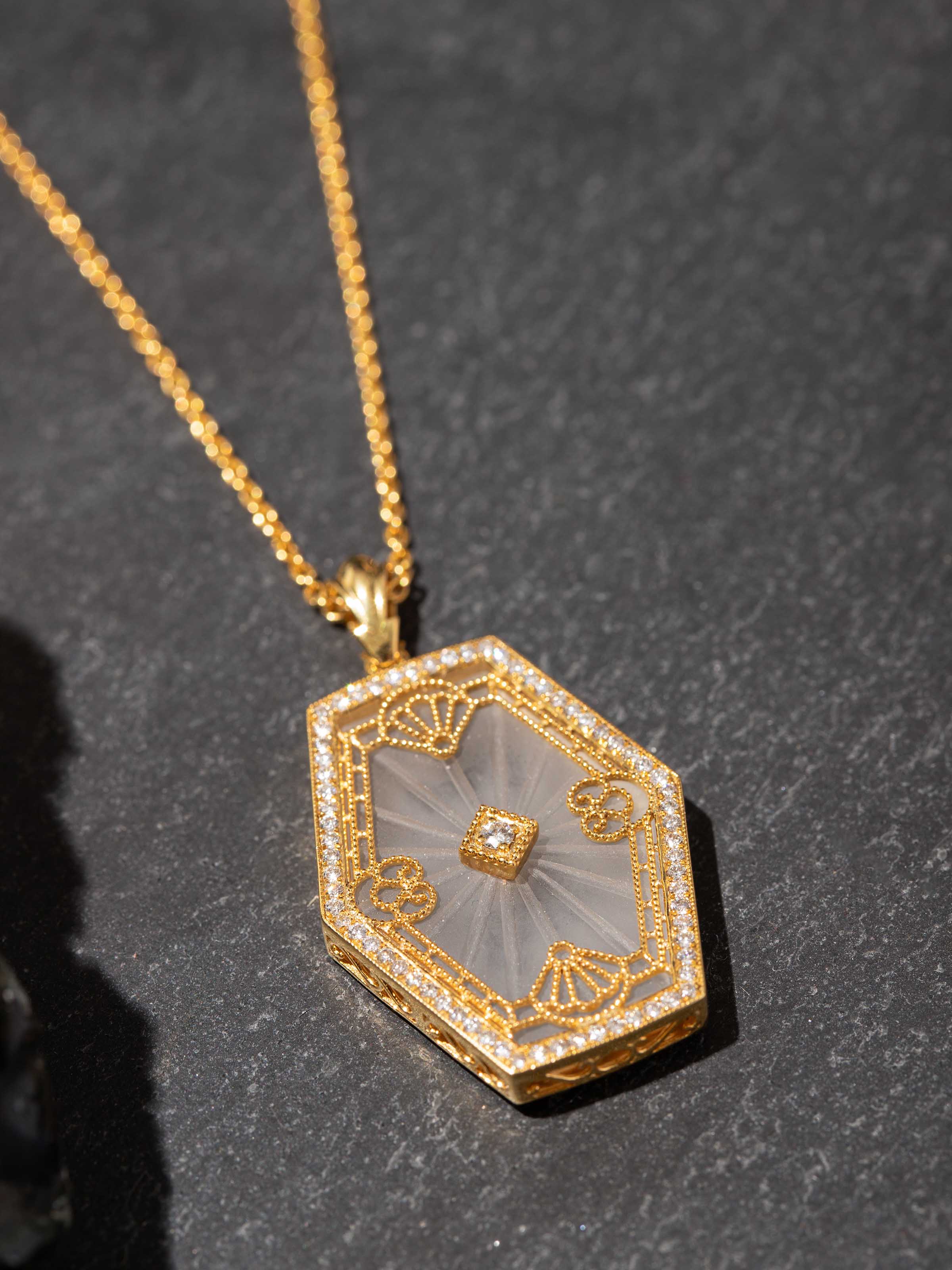 Close-up of gemstone setting on 14 karat gold pendant