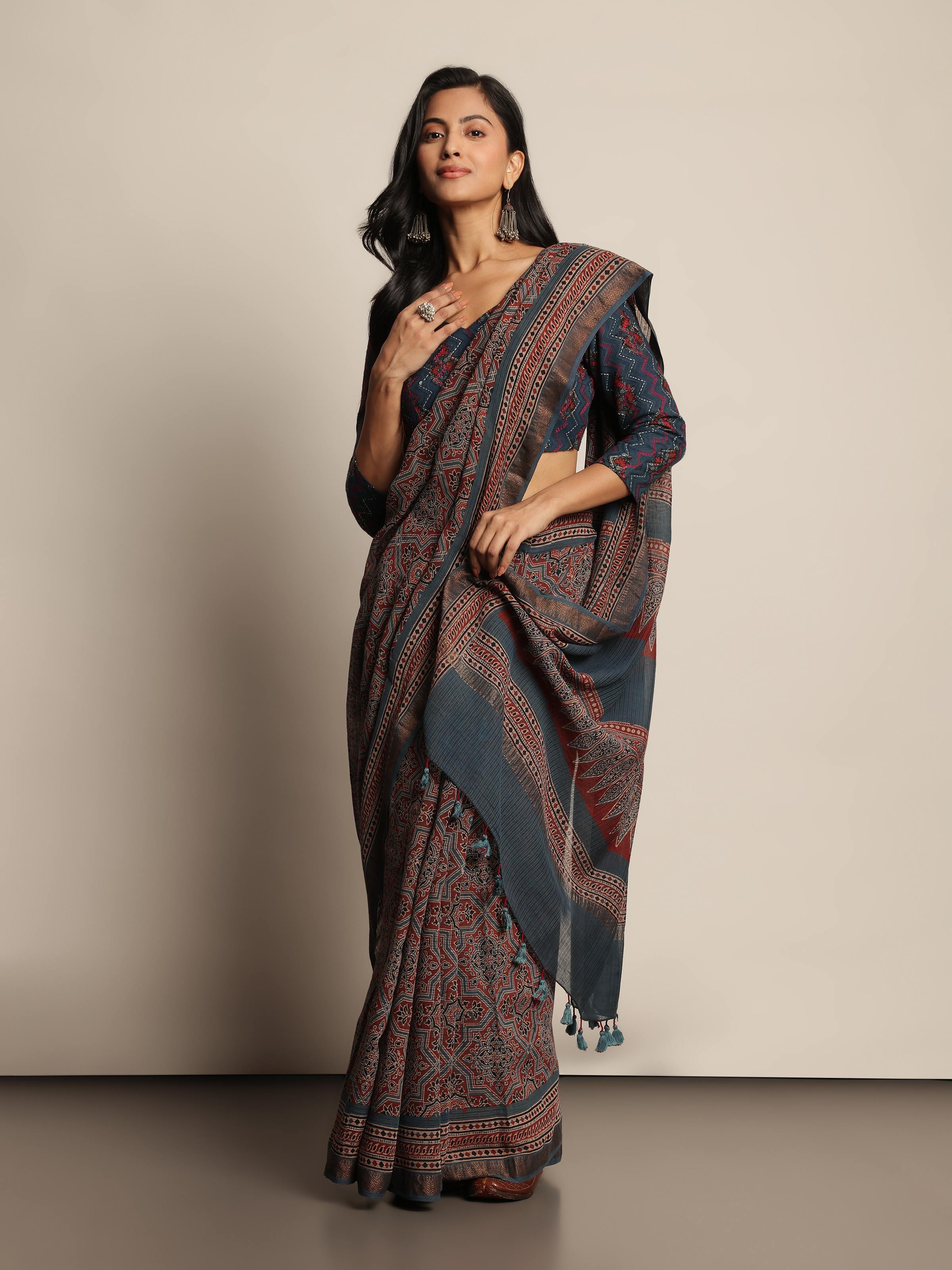 Lifestyle shot of blue Maheshwari Ajrakh saree draped elegantly with contrast border.