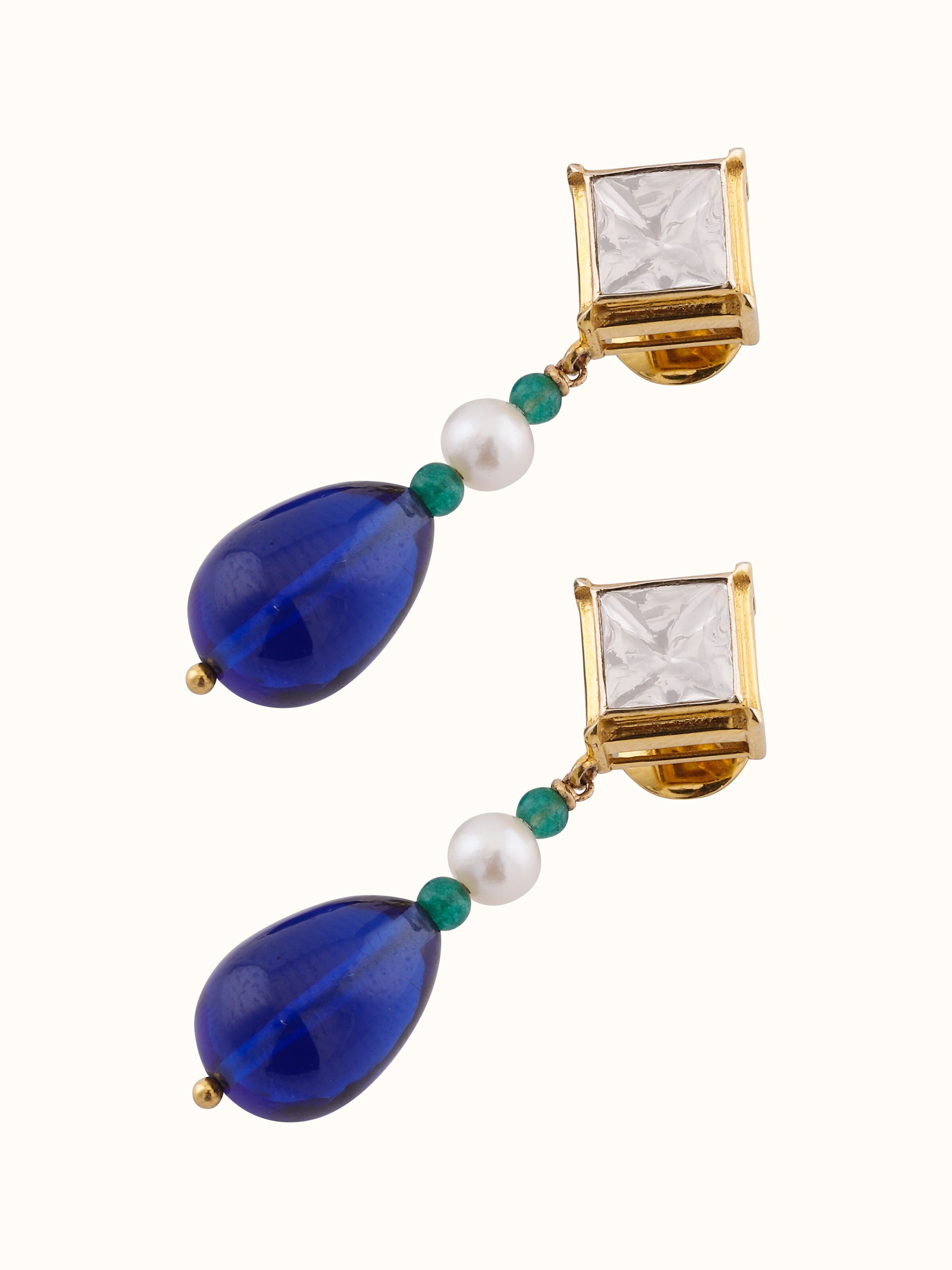 Overhead view of Dank Polki gold earrings revealing symmetrical arrangement and ornate finish.