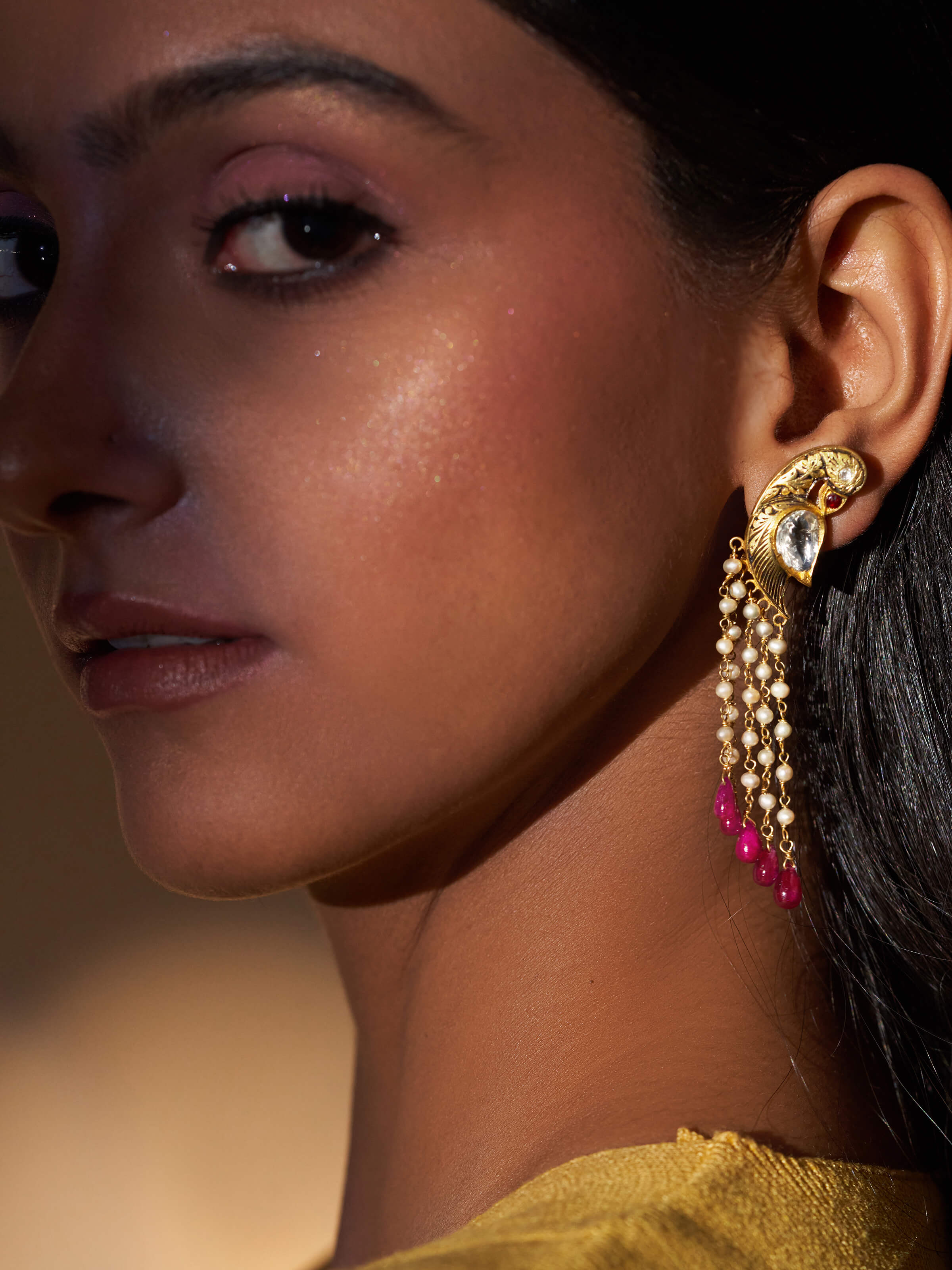 Side view of Partash 18 Karat Gold Drop Earrings highlighting their detailed design and luxurious finish.