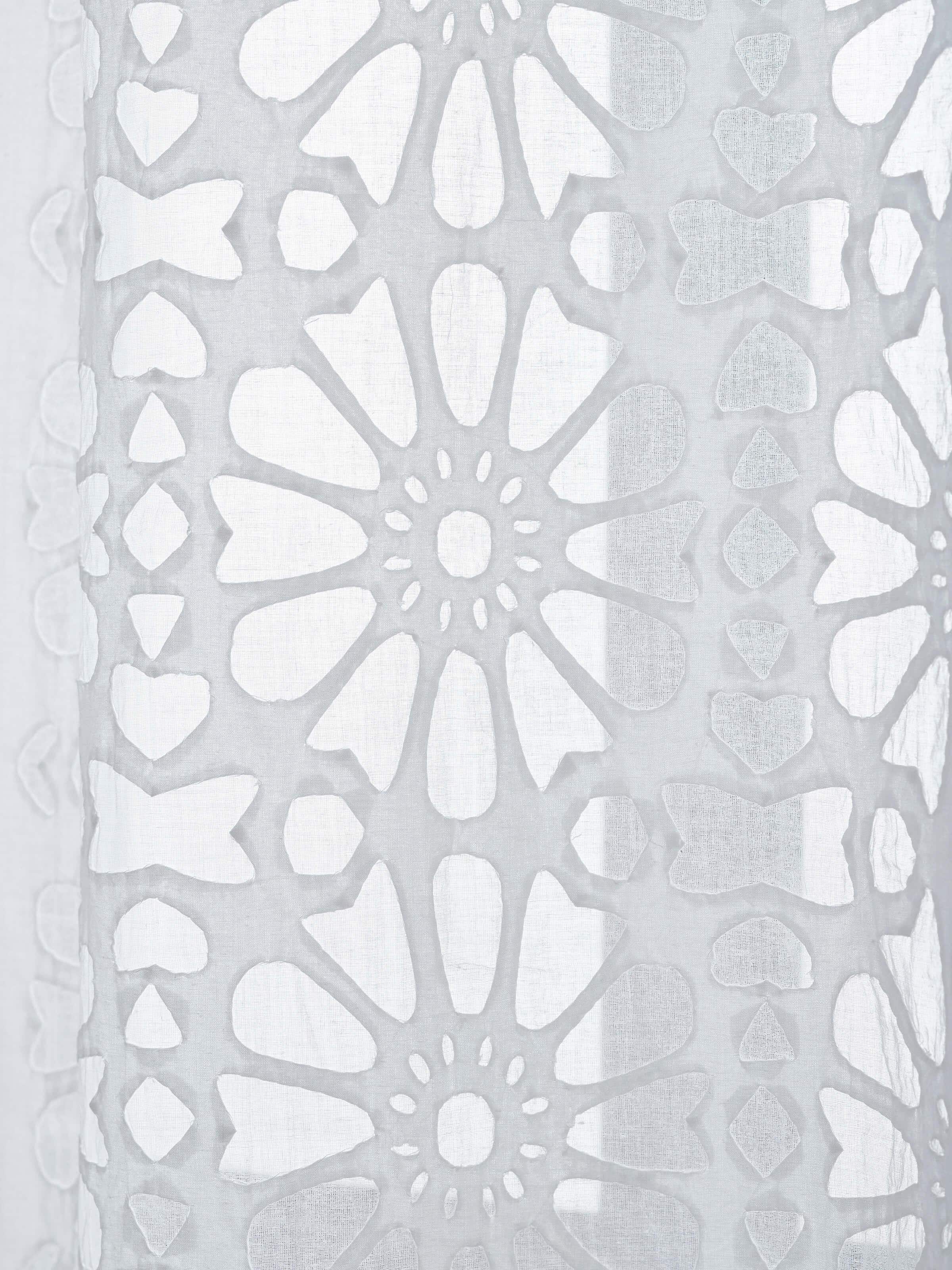 Side angle view showcasing texture and layered appliqué motifs on Mandana curtain