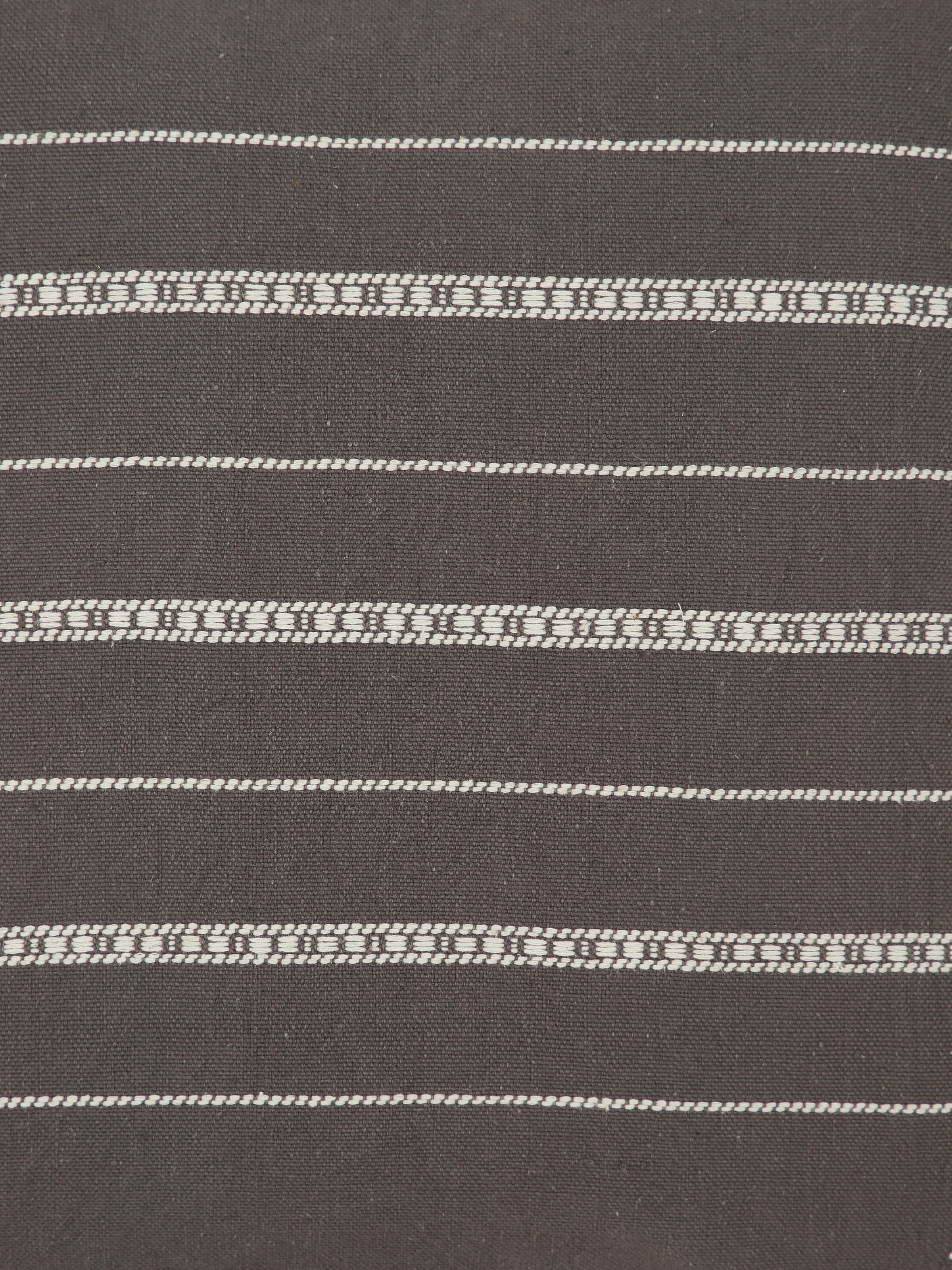 Detailed shot capturing the precision of the Bhujodi motifs and natural cotton fabric