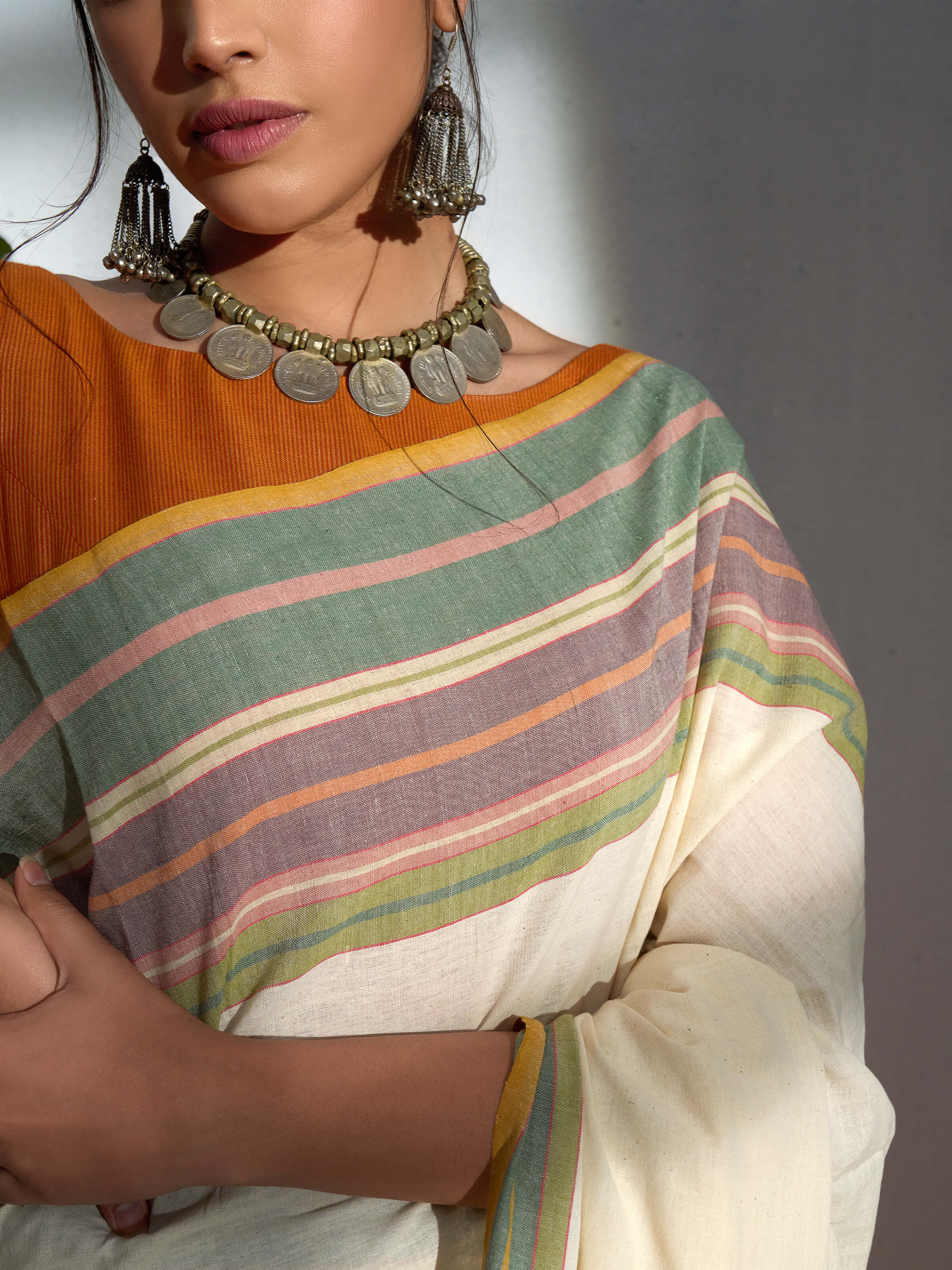 Detail view of cream cotton hand-spun striped saree showing fabric weave