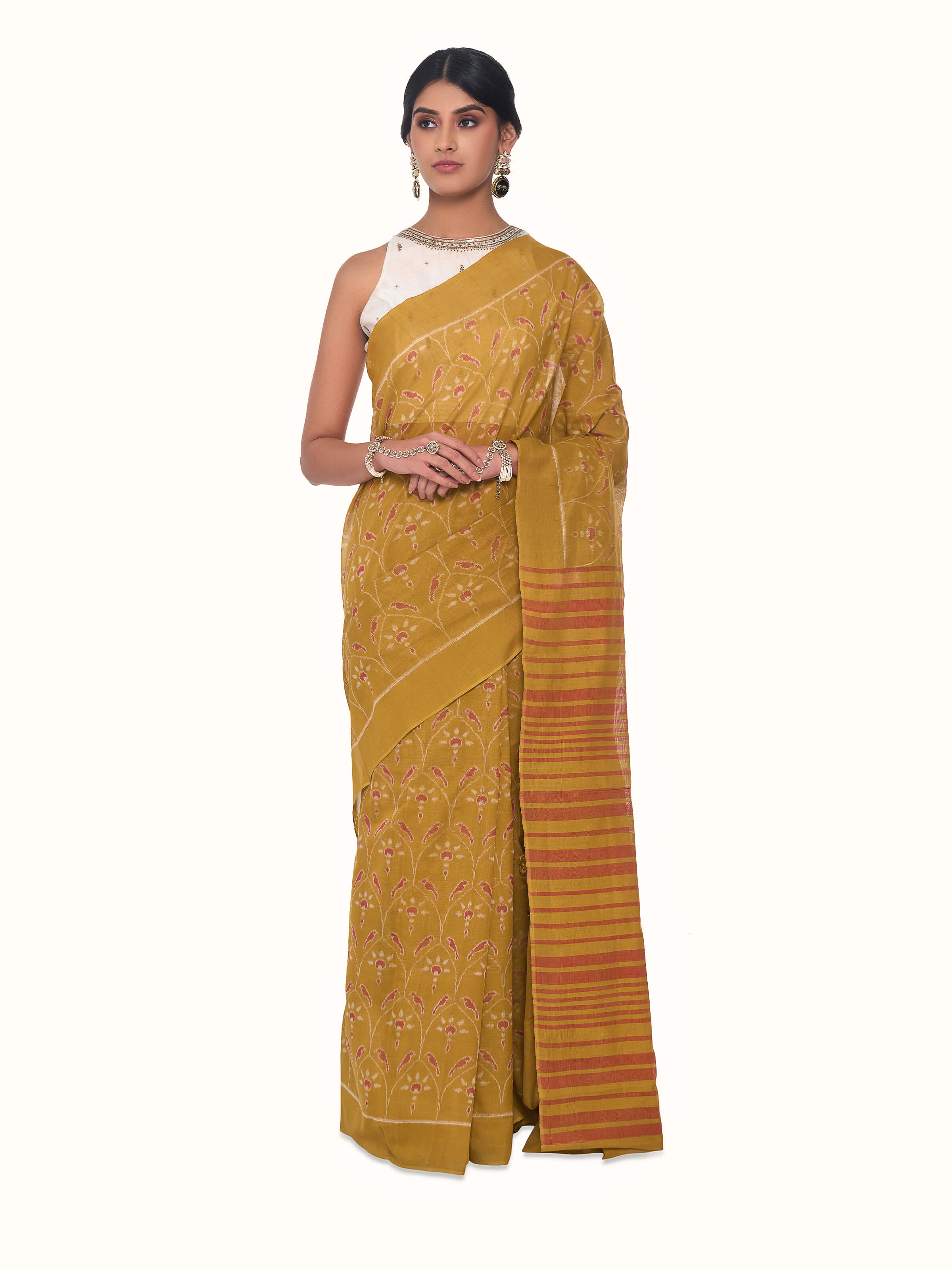 Front view of mustard cotton Odisha ikat bandha saree with traditional resist-dyed patterns