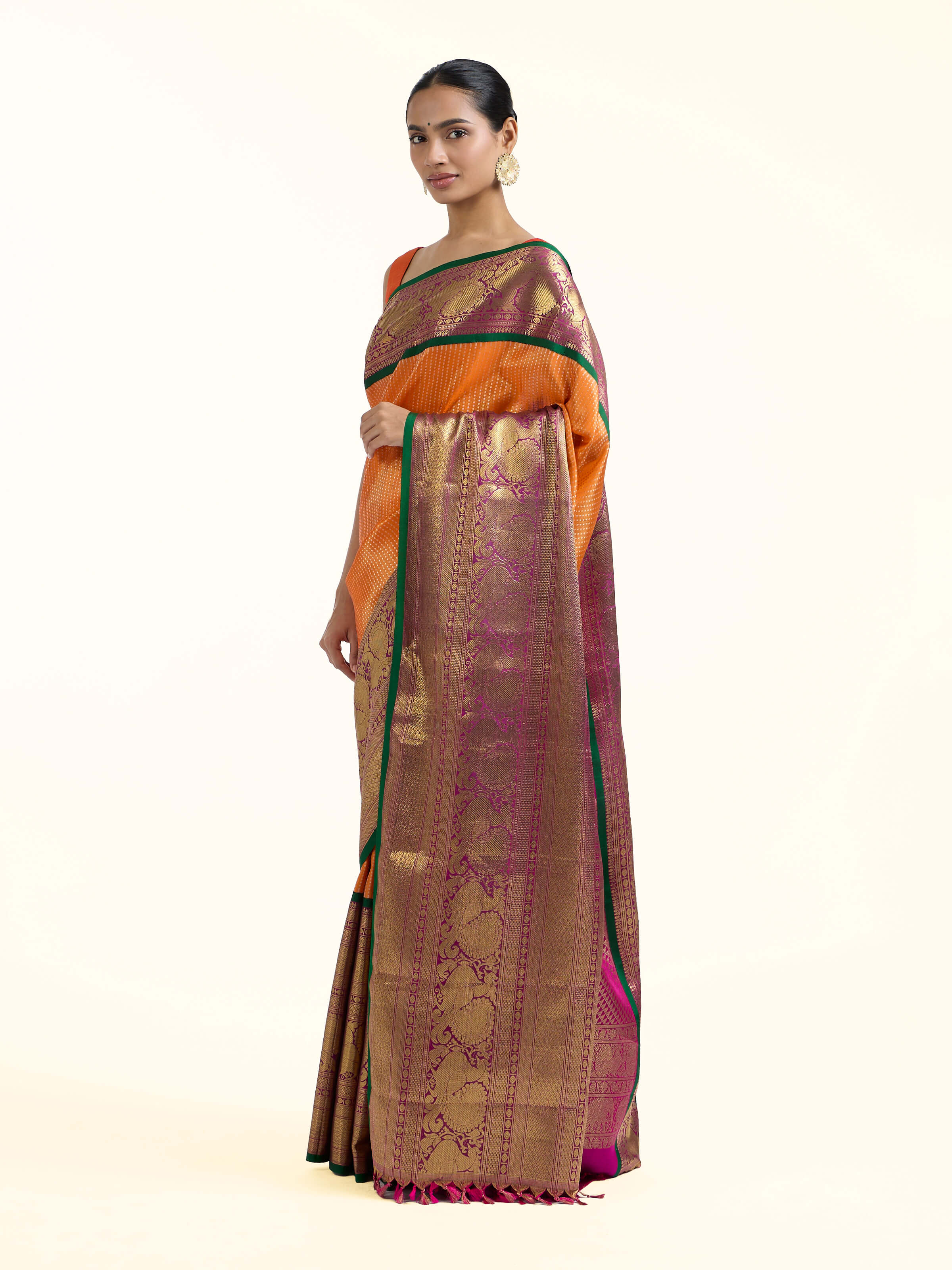 Side view of mango silk Kancheepuram saree showcasing contrast border
