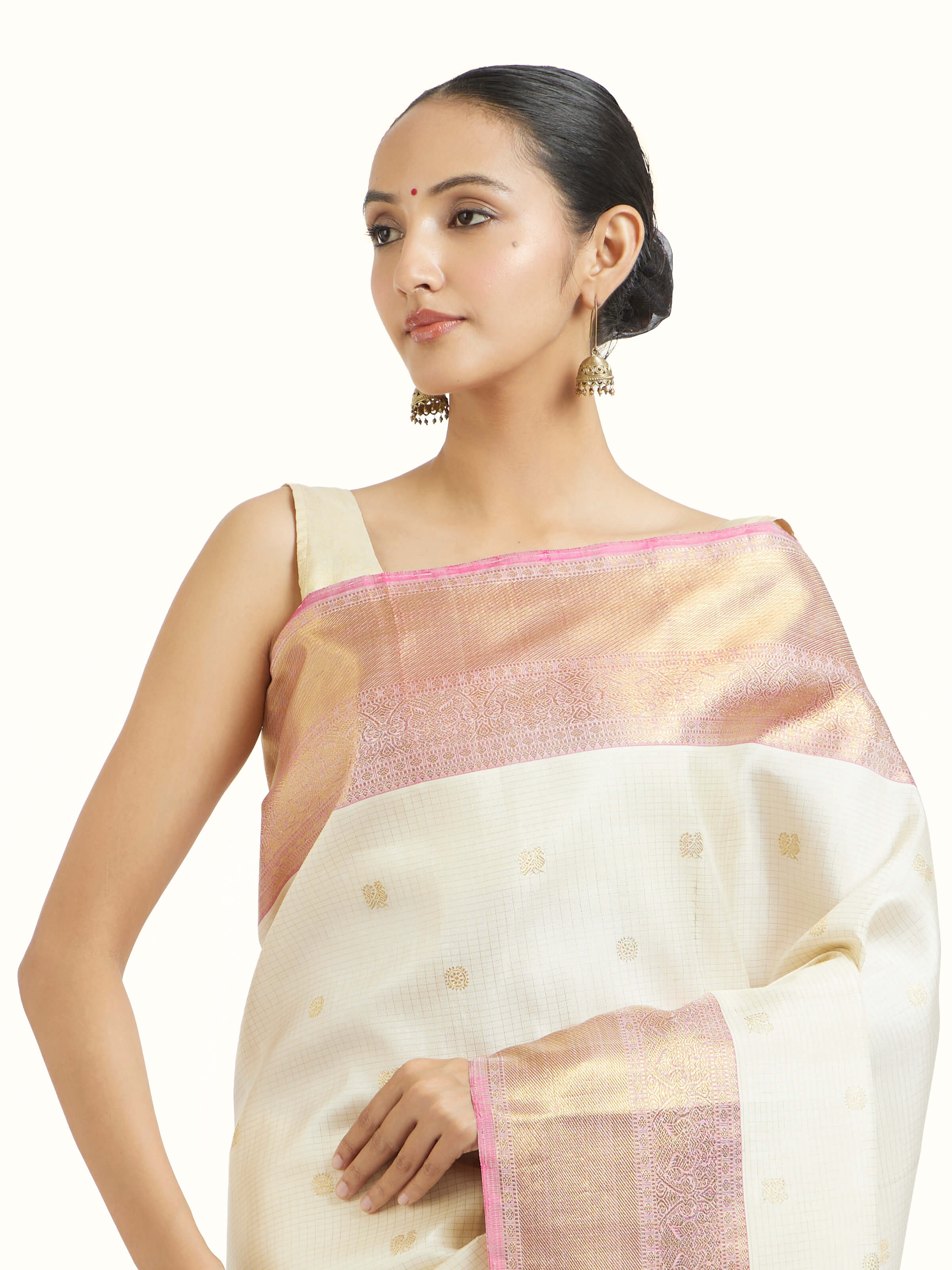 Angled view of off-white silk Kancheepuram saree showing traditional craftsmanship