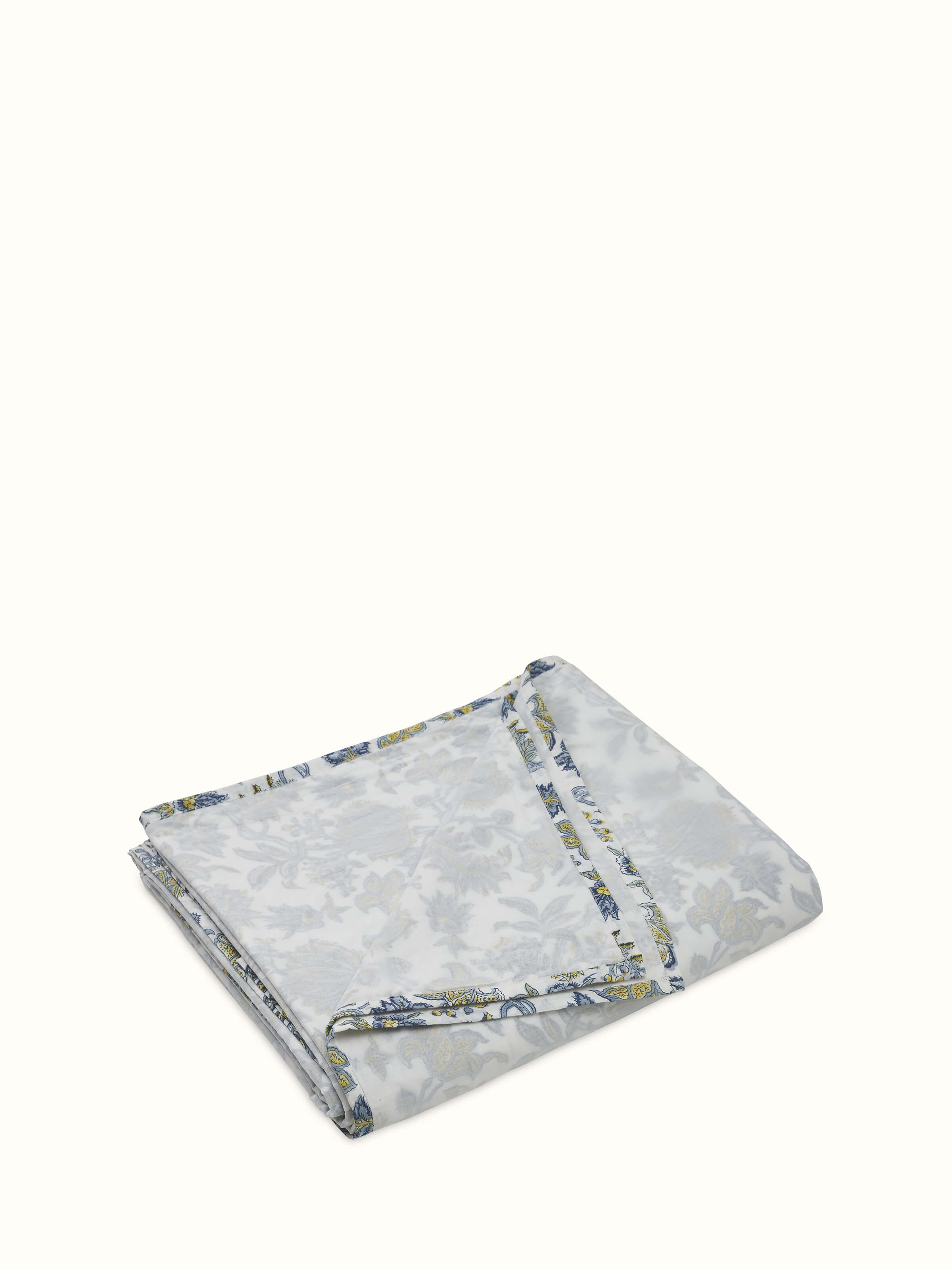 Angled detail of hand block-printed motifs in soothing blue on breathable cotton.