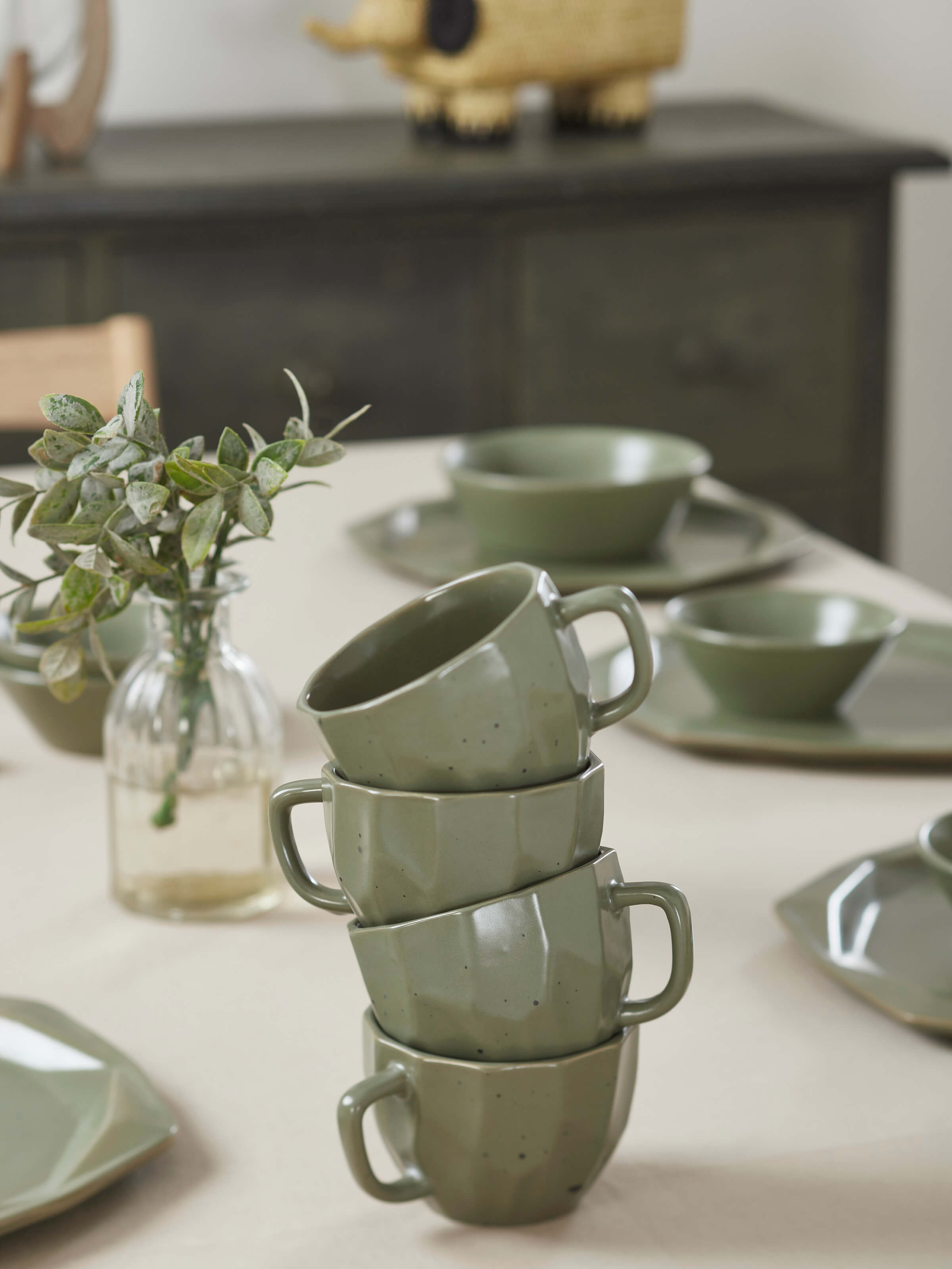 Angled view of Khurja pottery ceramic coffee mugs in green (4 pcs) emphasizing the elegant handle and traditional design