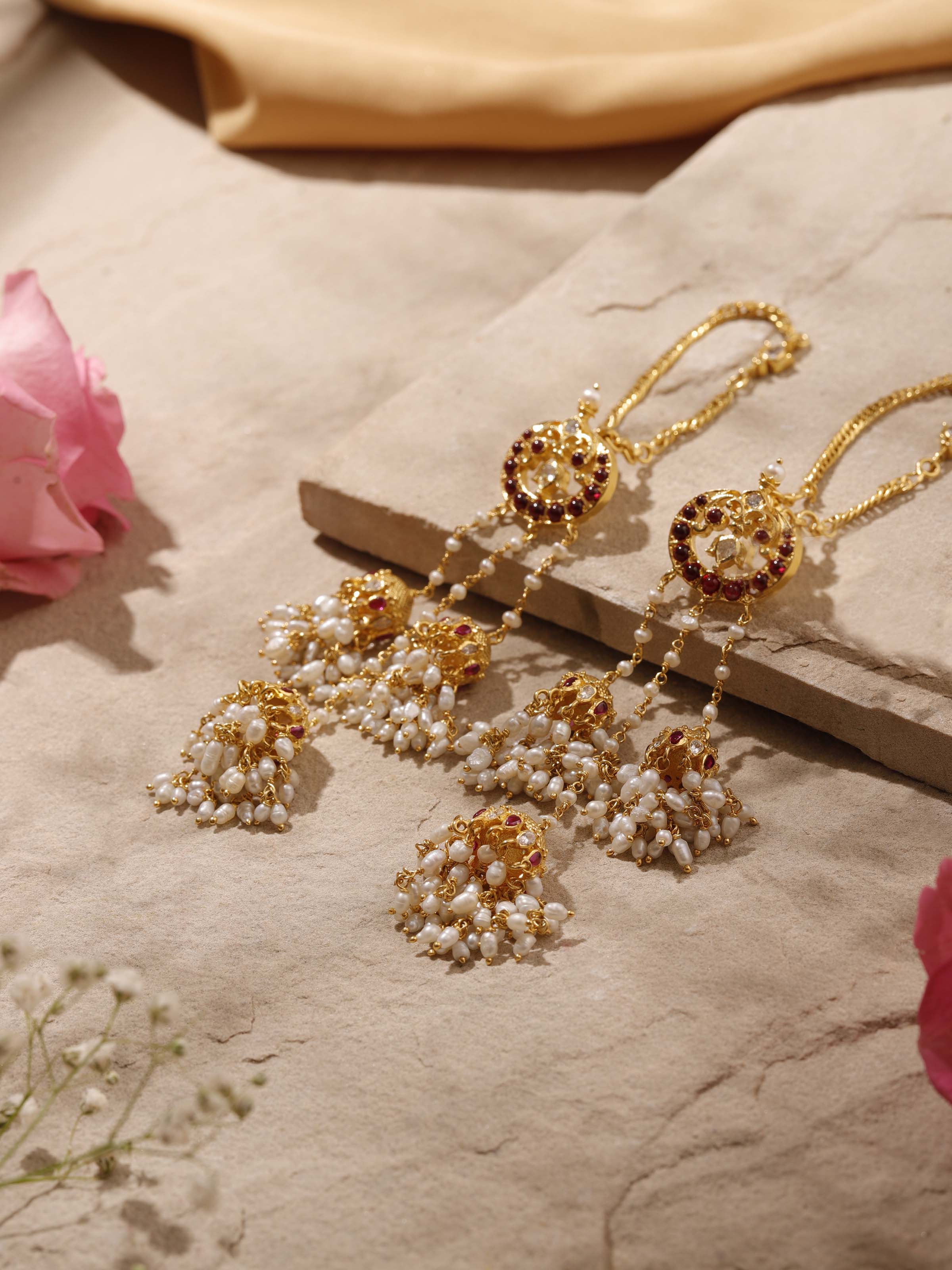 Overhead view of Guttapusalu silver drop earrings revealing symmetrical design and heritage styling