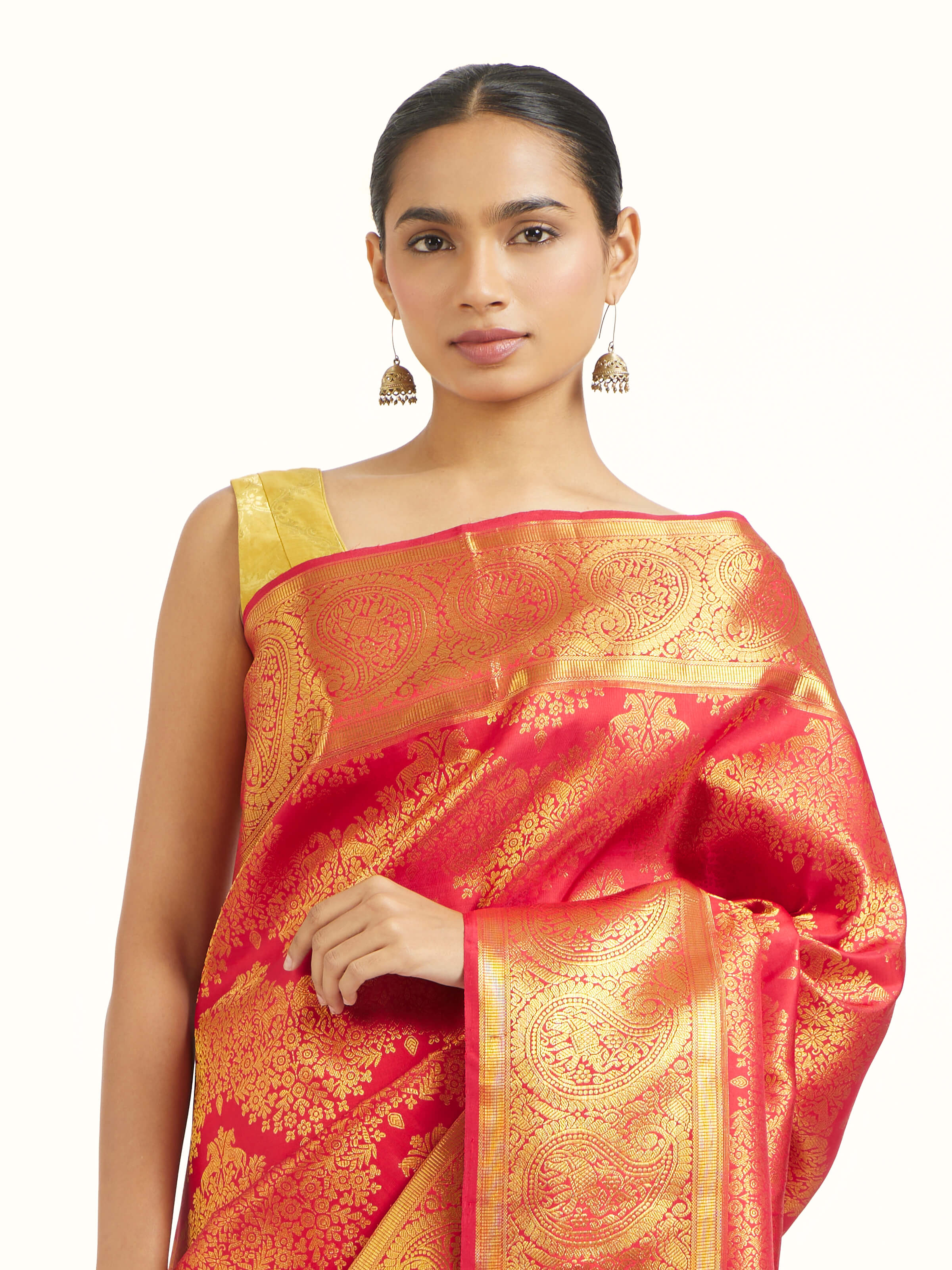 Angled view of red silk Kancheepuram saree highlighting traditional weave and sheen