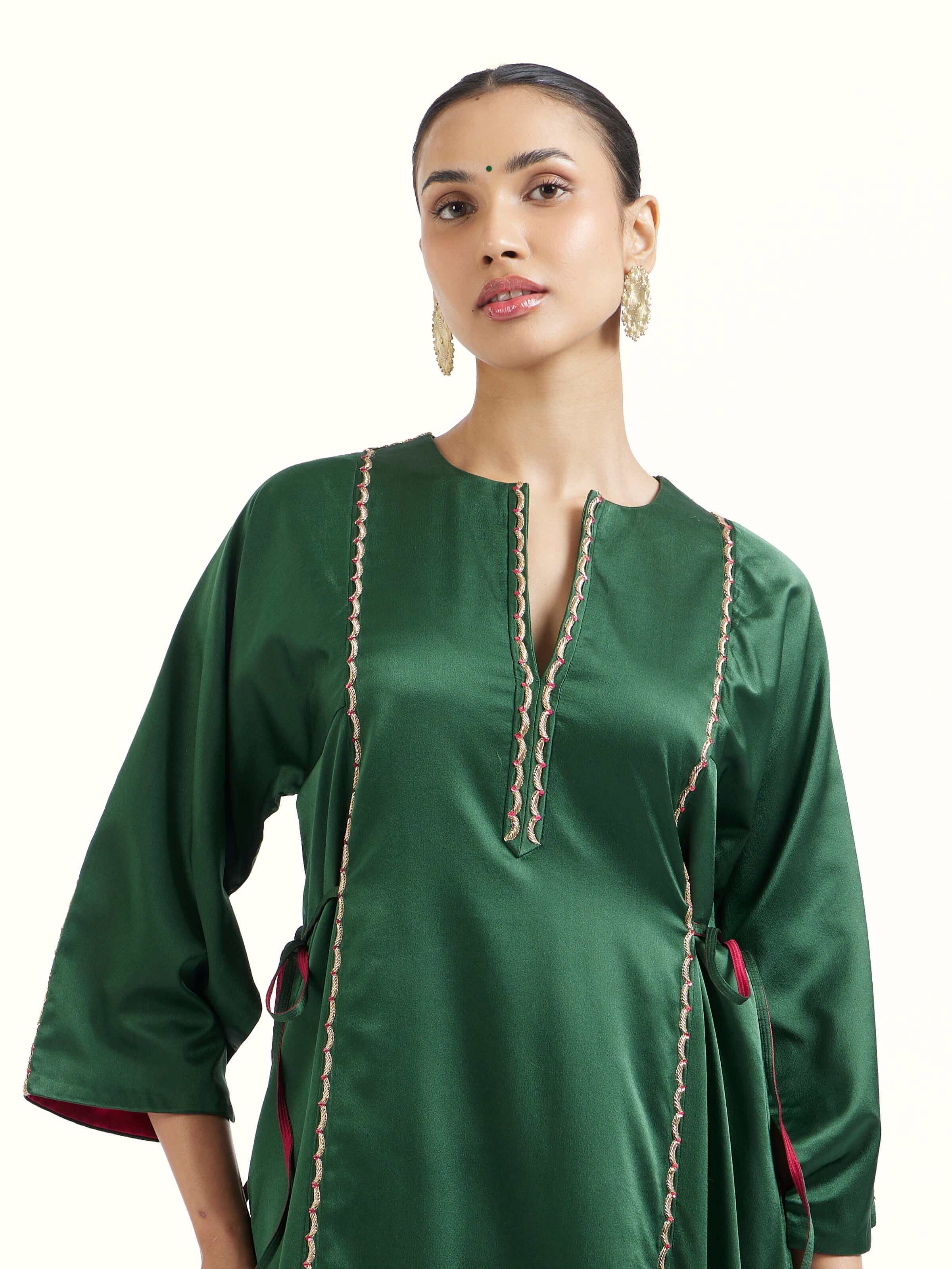 Angled view of emerald green silk Banarasi co-ord set emphasizing woven details