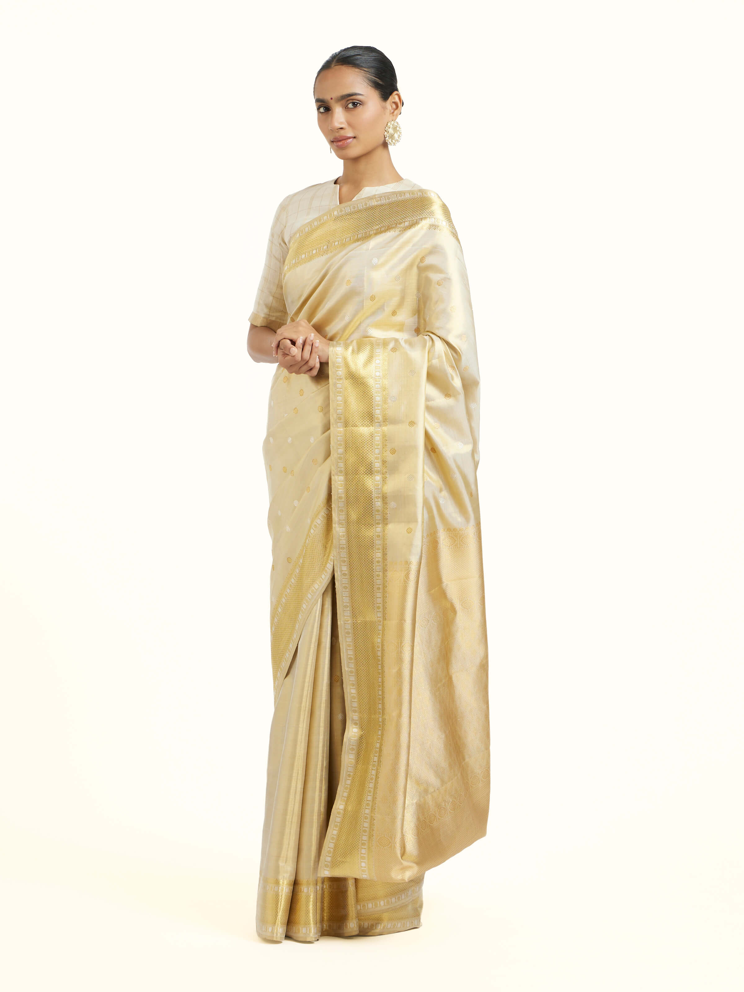 Side view of beige silk Kancheepuram saree with elegant drape and contrast border