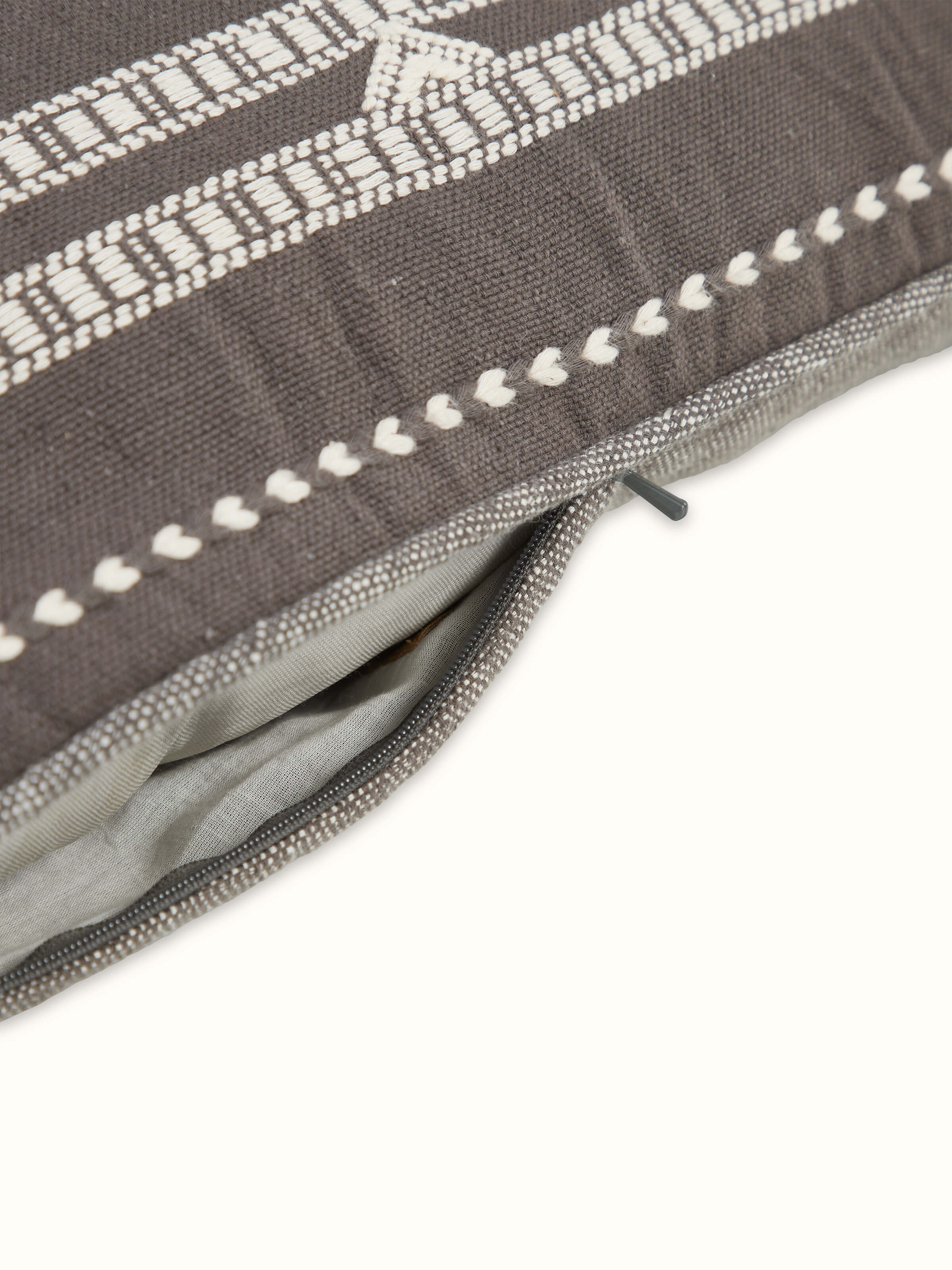 Angled view of Anek Coffee Handloom Cushion Cover showcasing pattern and structure