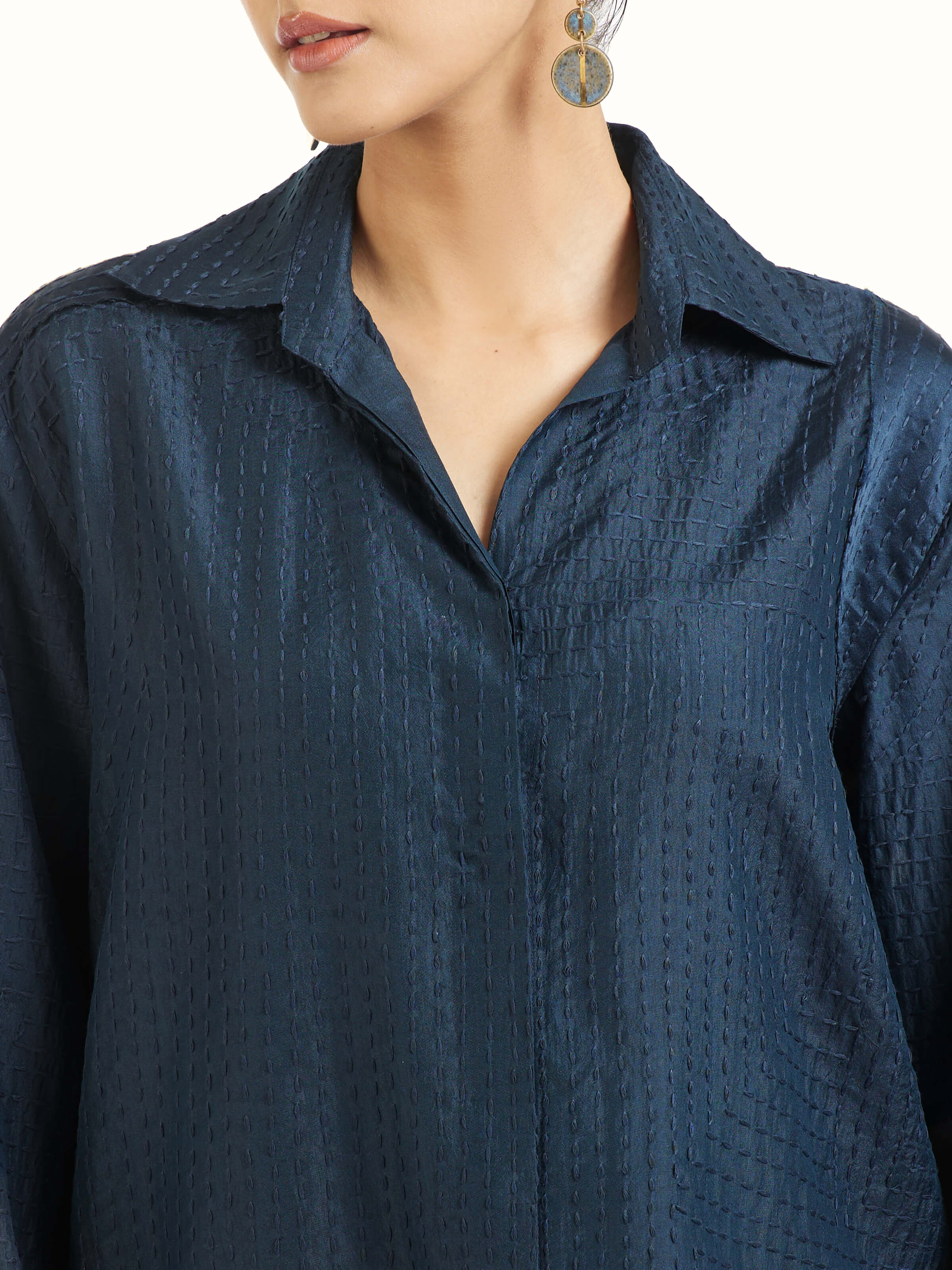 Detail view of blue silk kantha shirt showing stitch work and fabric texture