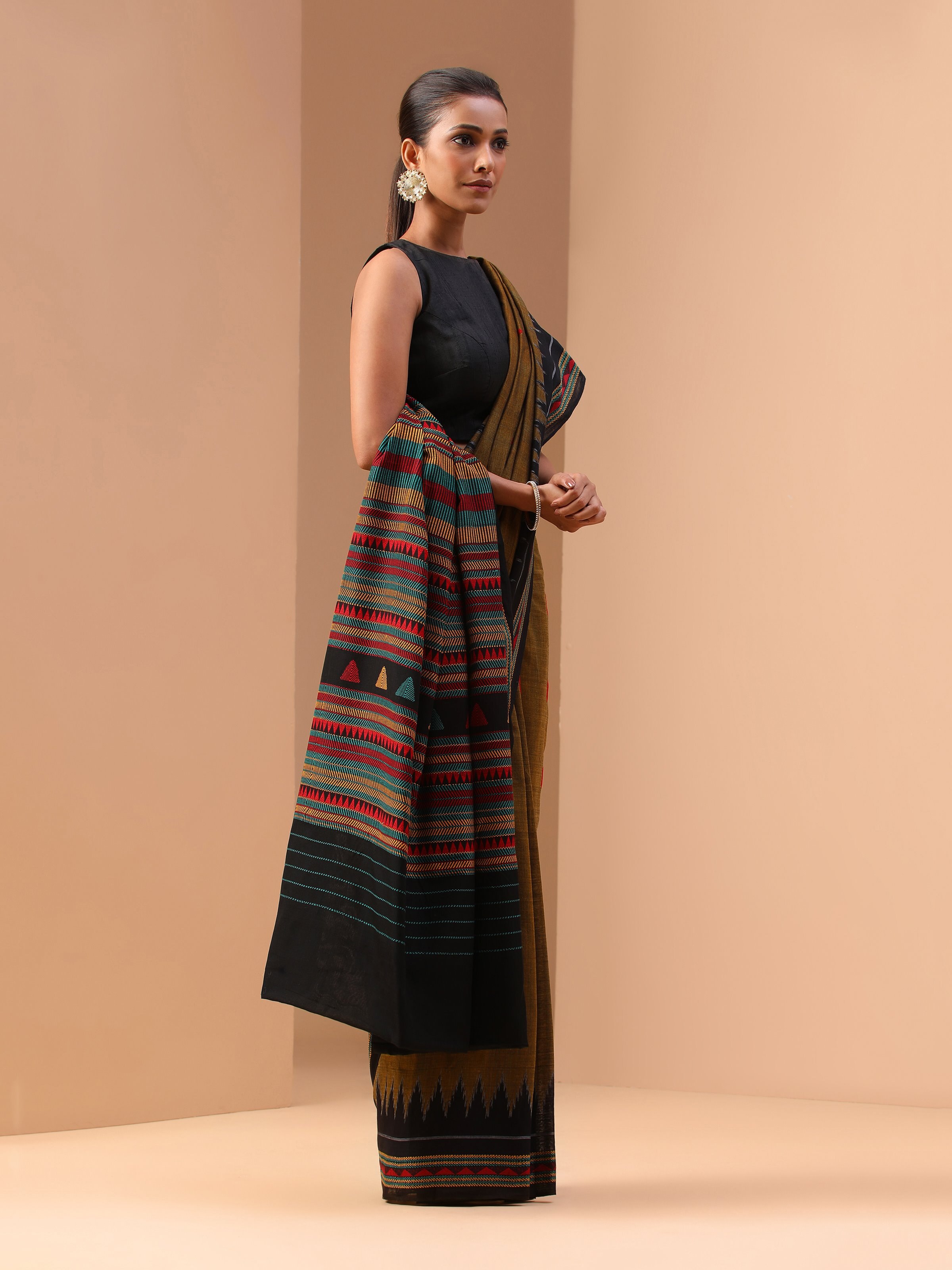 Angled view of yellow cotton saree highlighting texture and artisanal design