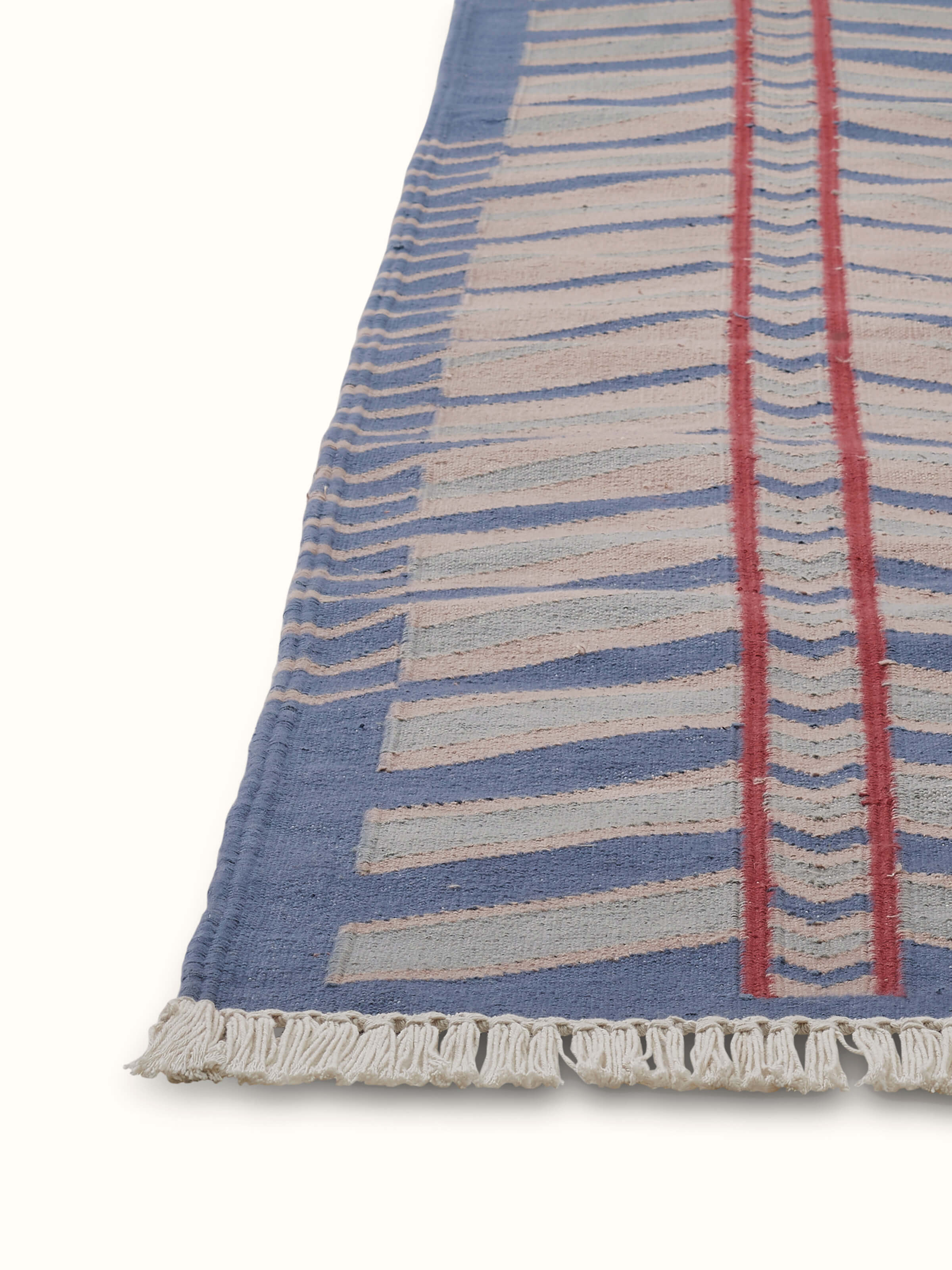 Detailed view of Geo chevron gradation blue beige lawan cotton panja dhurrie showing the chevron pattern and fabric quality.