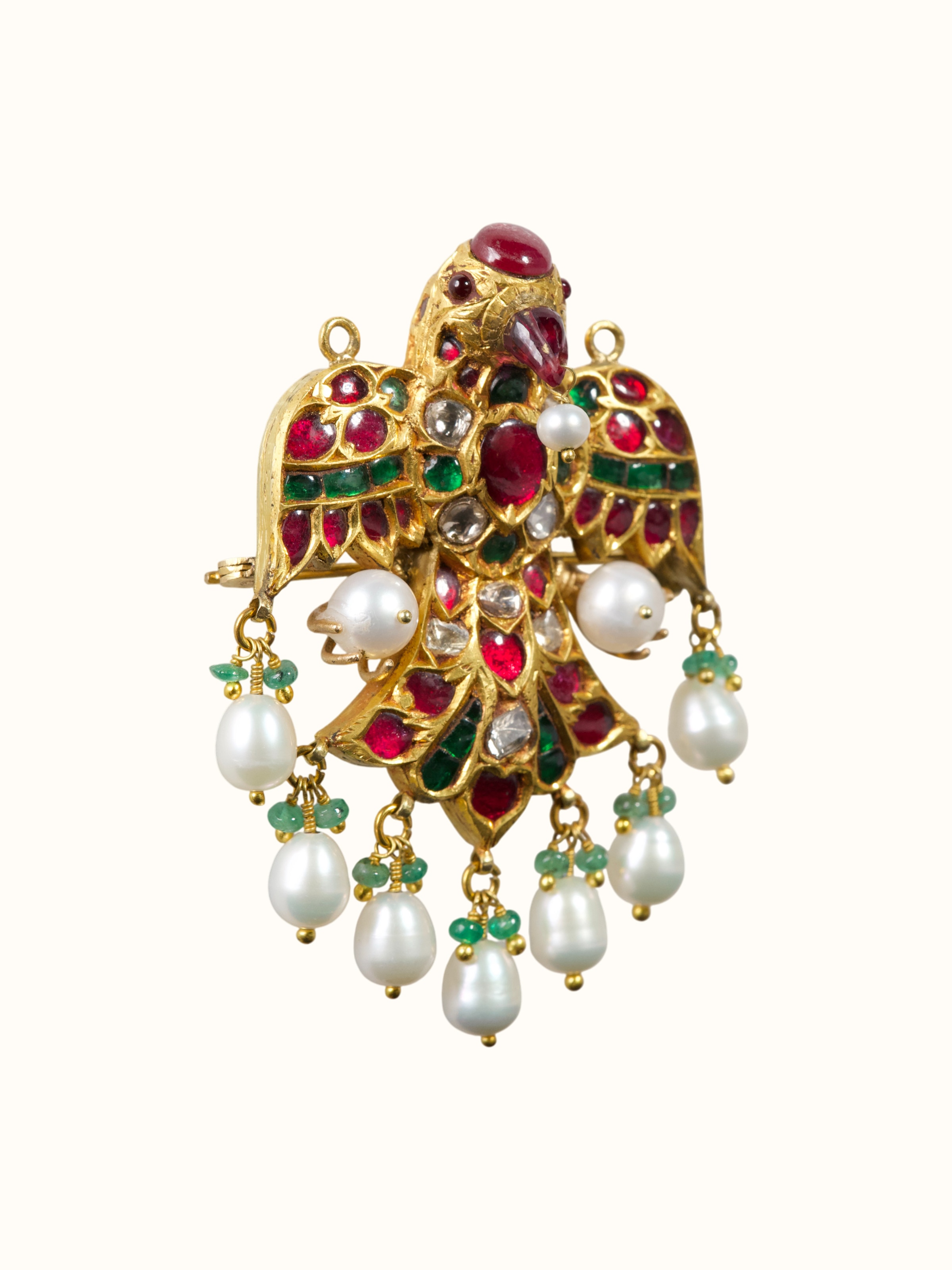 front view of jadau gold brooch pin with traditional stone setting