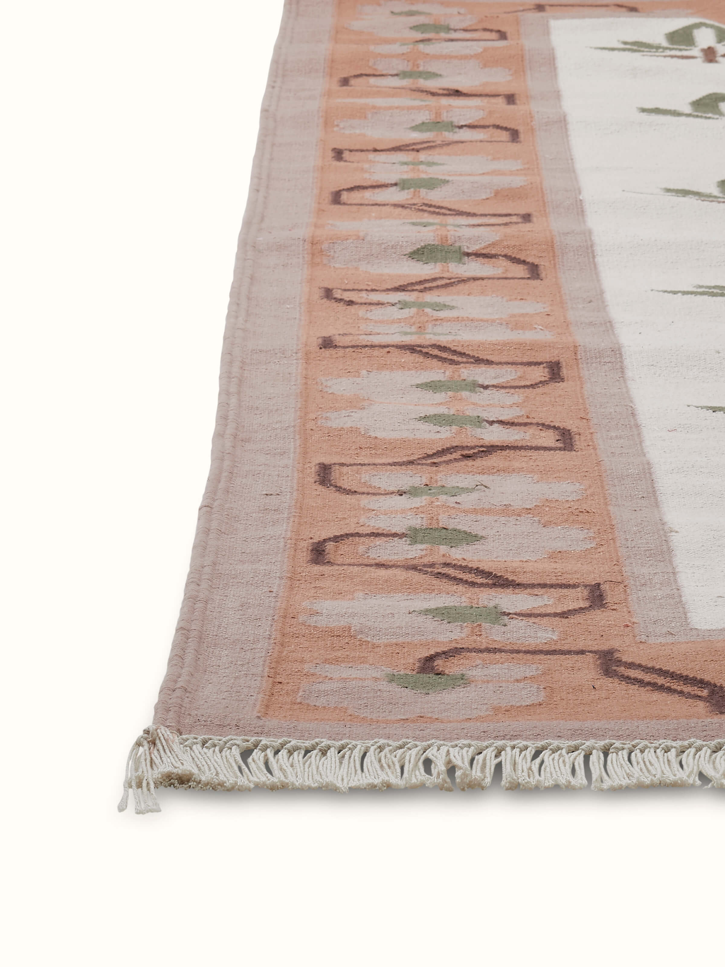 Close-up view of Contemporary lotus blush lawan cotton panja dhurrie, emphasizing the lotus design and fabric texture.