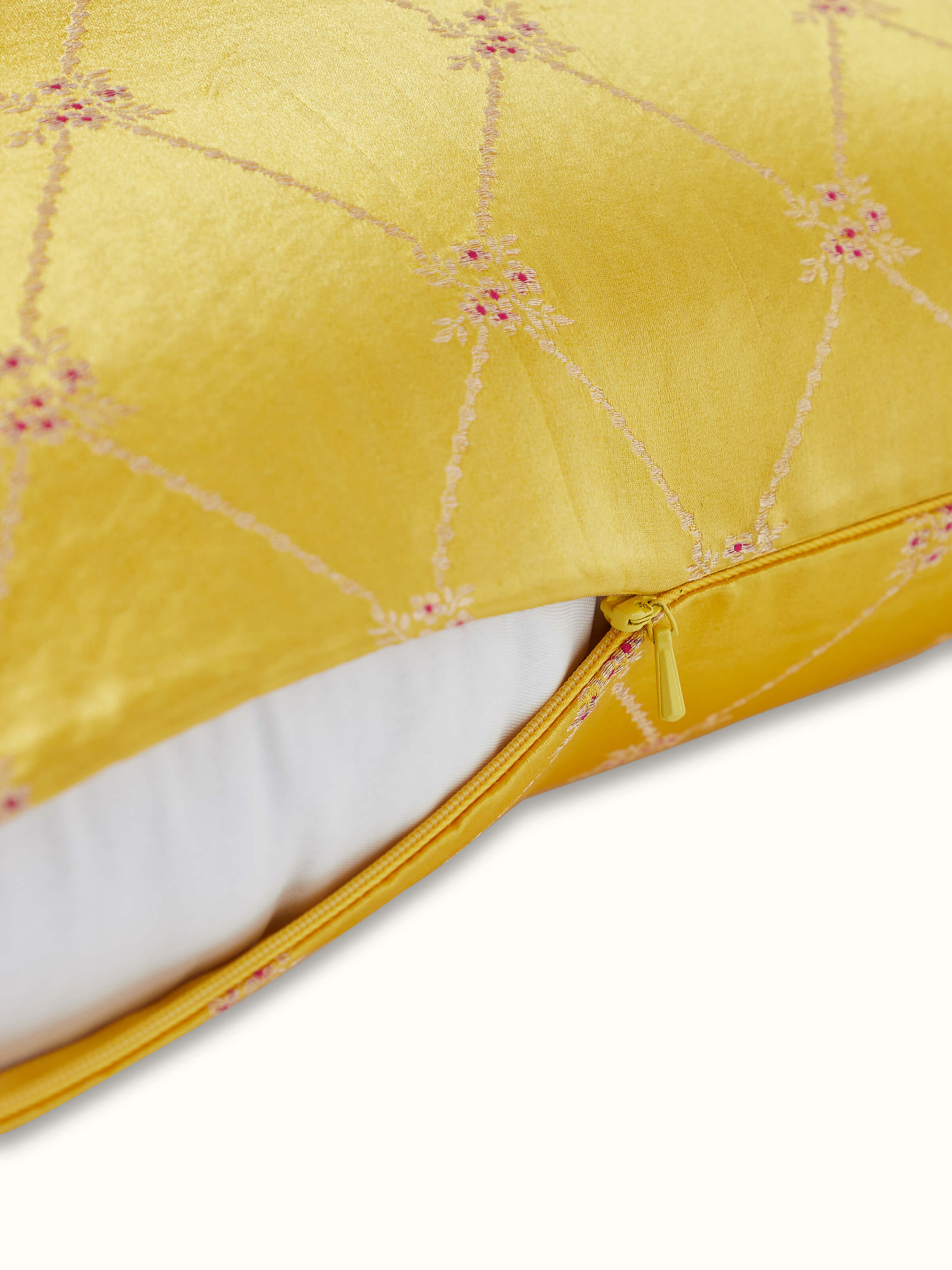 Angled image showing the golden detailing and luxurious silk texture.