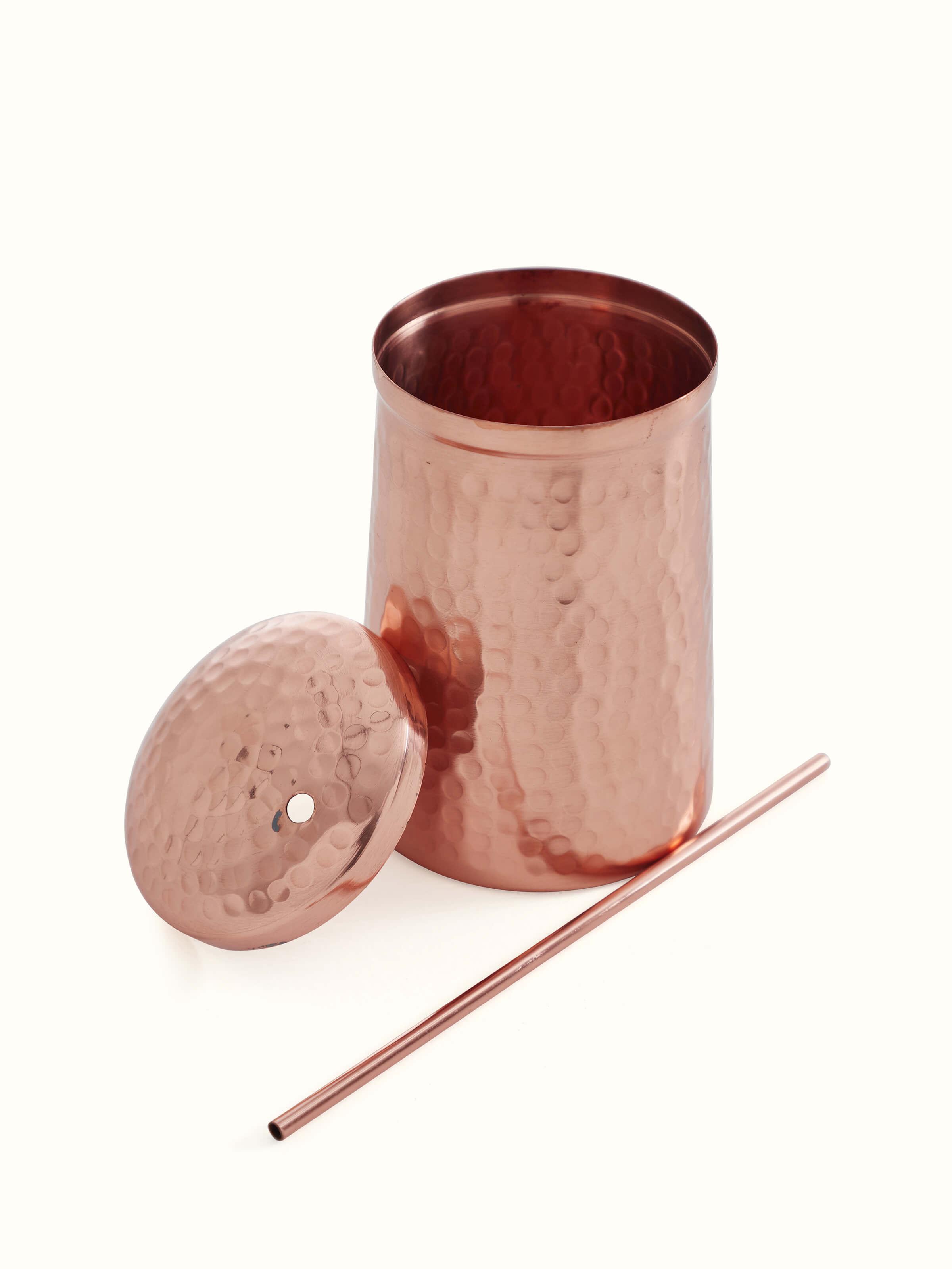 Angled view of Copper Water Glass by Swadesh showcasing its rich copper color and seamless finish.