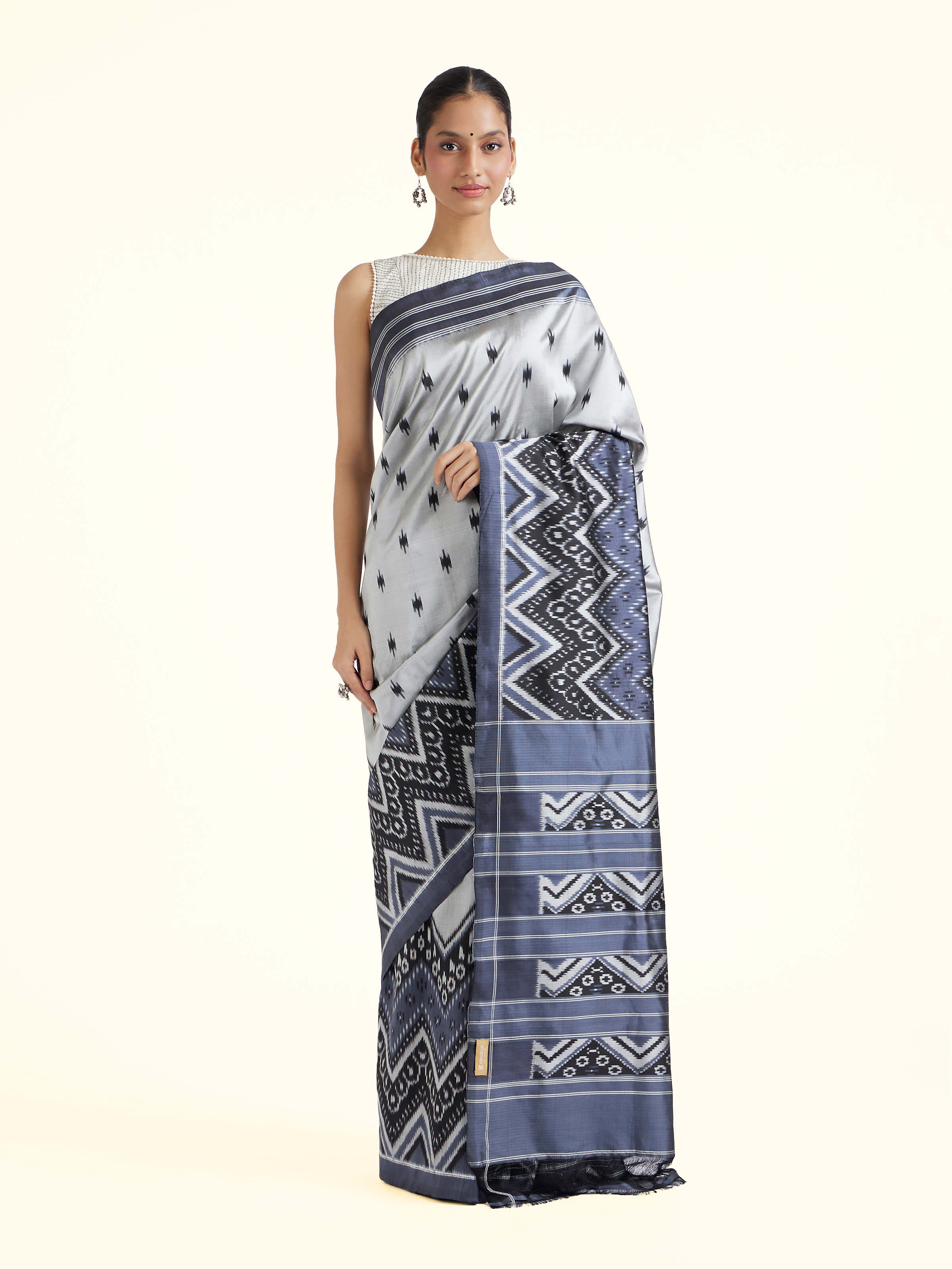 Front view of off-white mulberry silk ikat saree showcasing ikat motifs