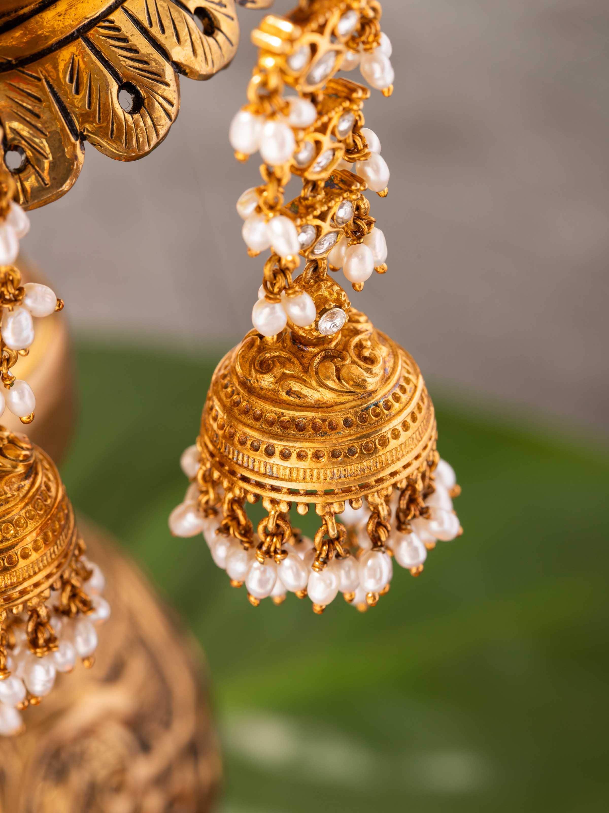 Detail shot of Guttapusalu earrings featuring cascading pearls and intricate dome structure.