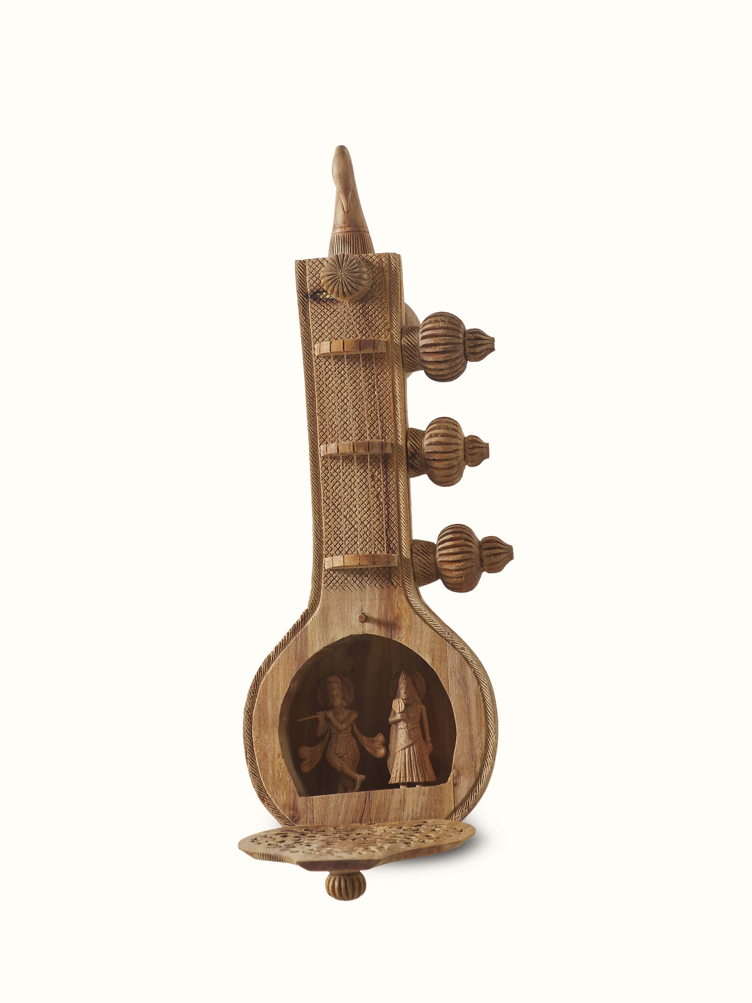 Close-up view of carved sandalwood Vandana Veena sculpture focusing on detailed carvings