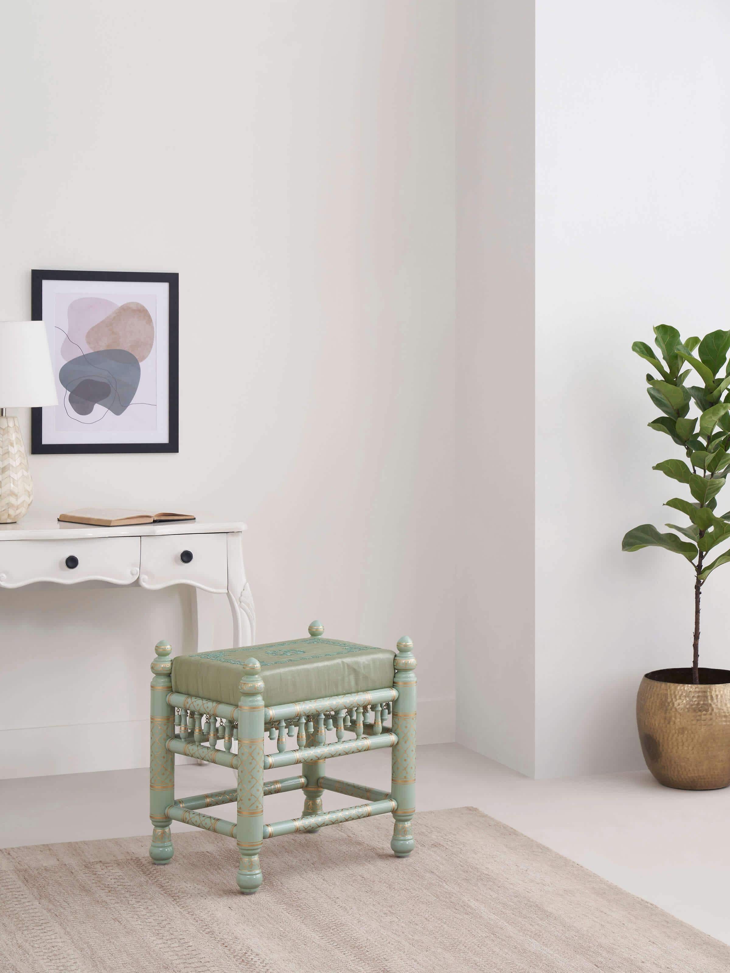 Side view of Upholstered Teak Wood Sankheda Rectangle Stool showcasing the elegant woodwork and comfortable upholstery.