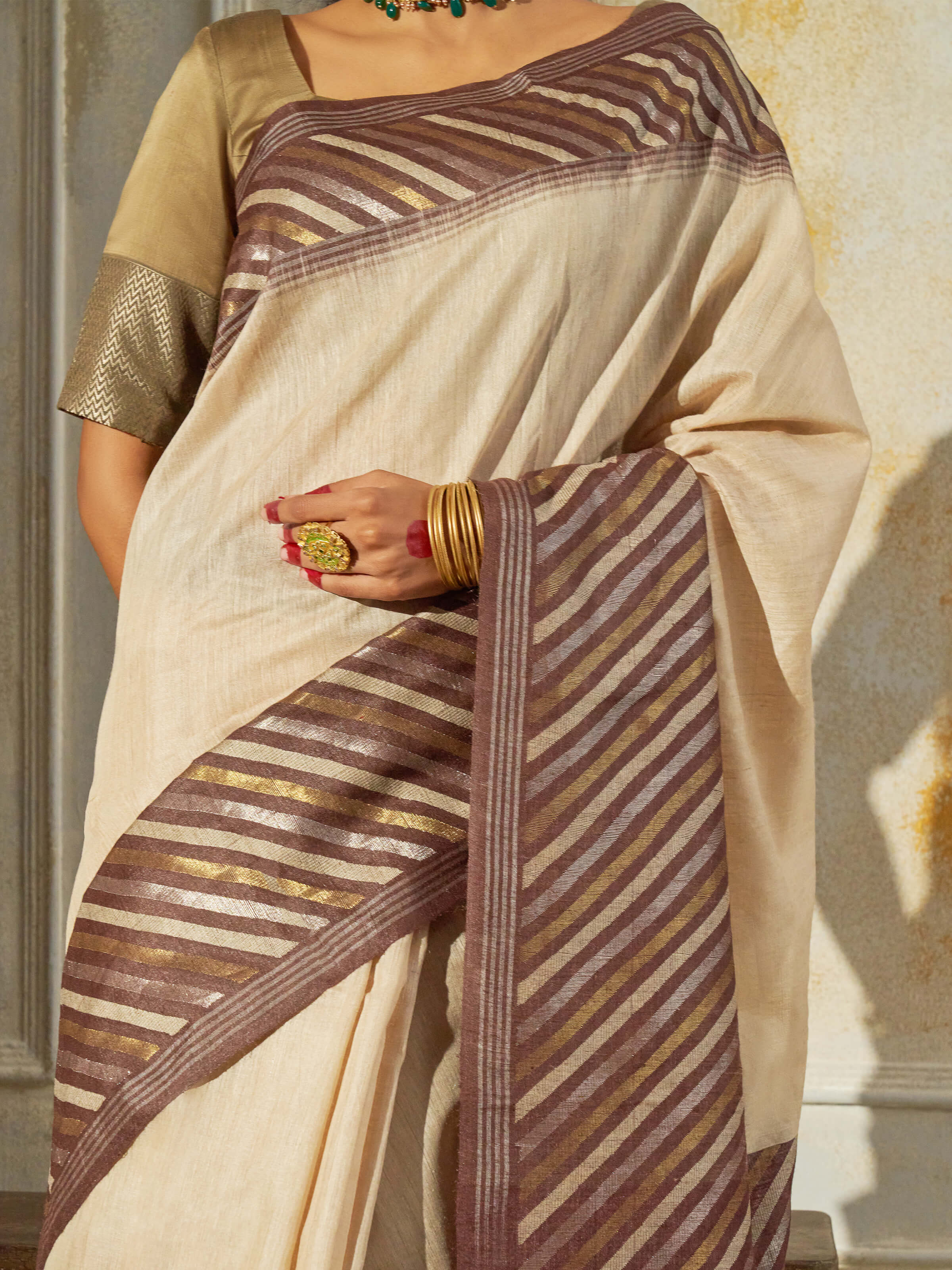 Detail view of beige tussar muga silk saree showing silk texture