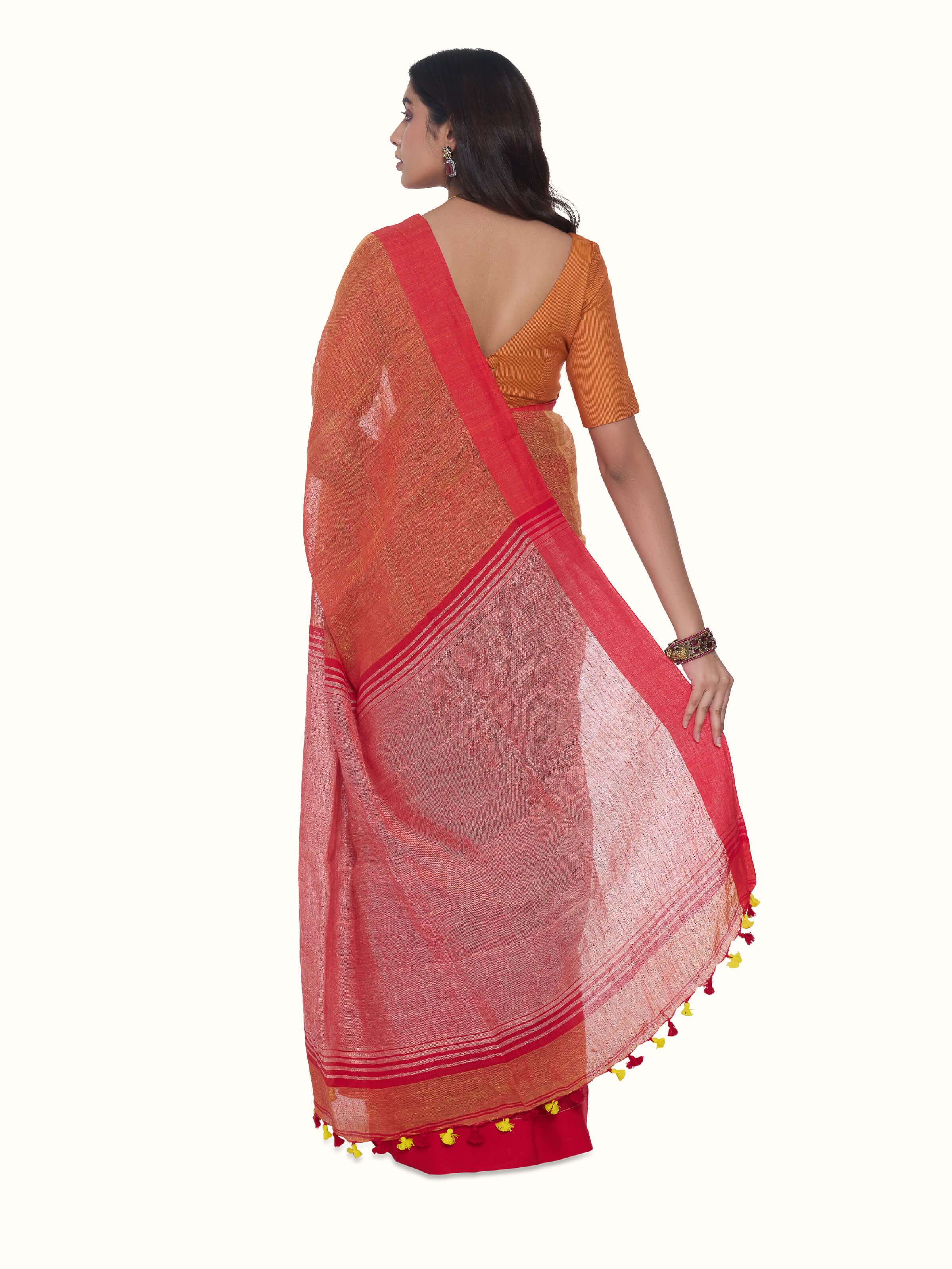 Back view of orange linen saree displaying full length and fall