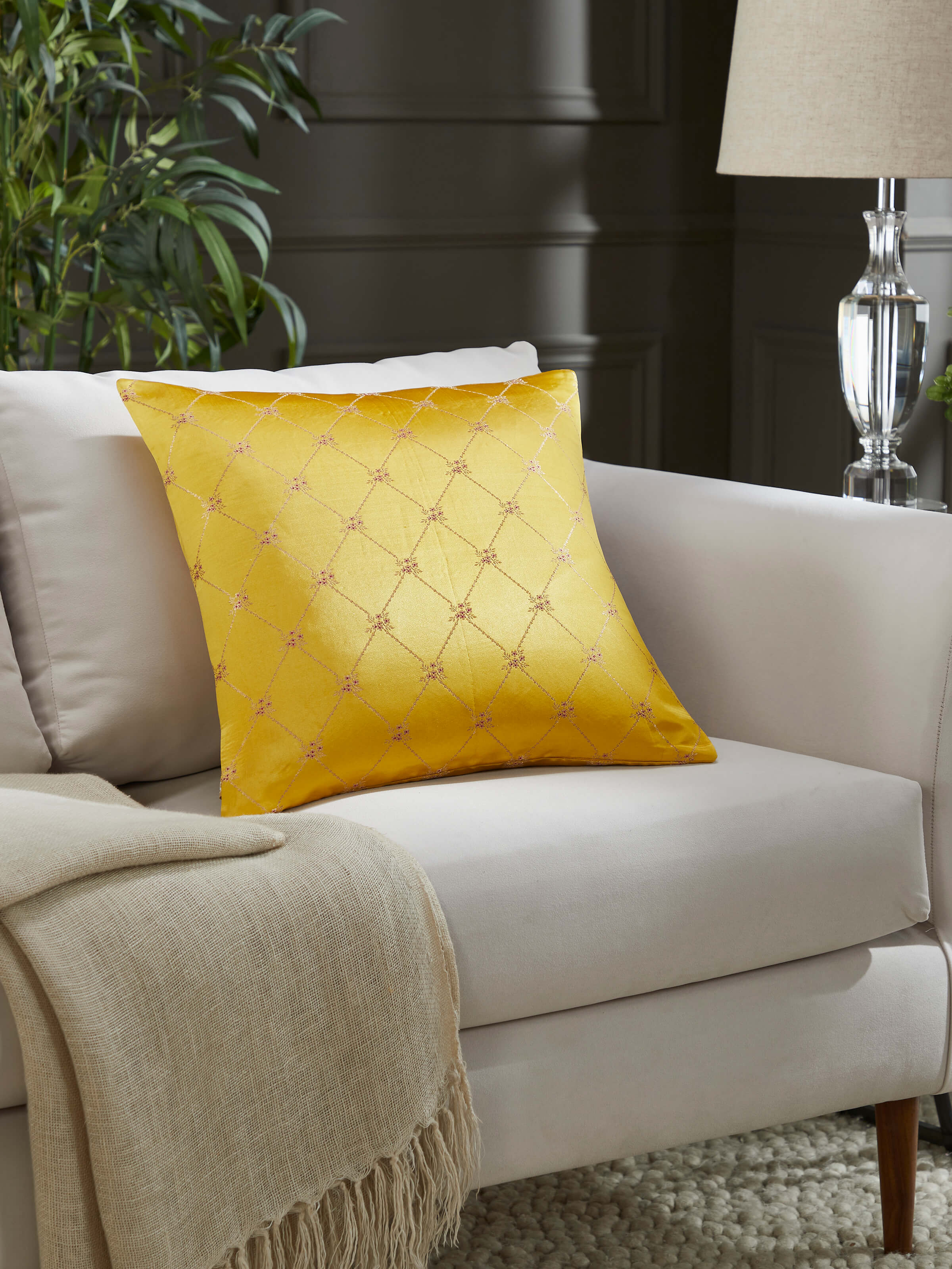 Lifestyle view of Awadh Yellow Banarasi Cushion Cover on a sofa, enhancing the space with regal charm and handloom elegance.