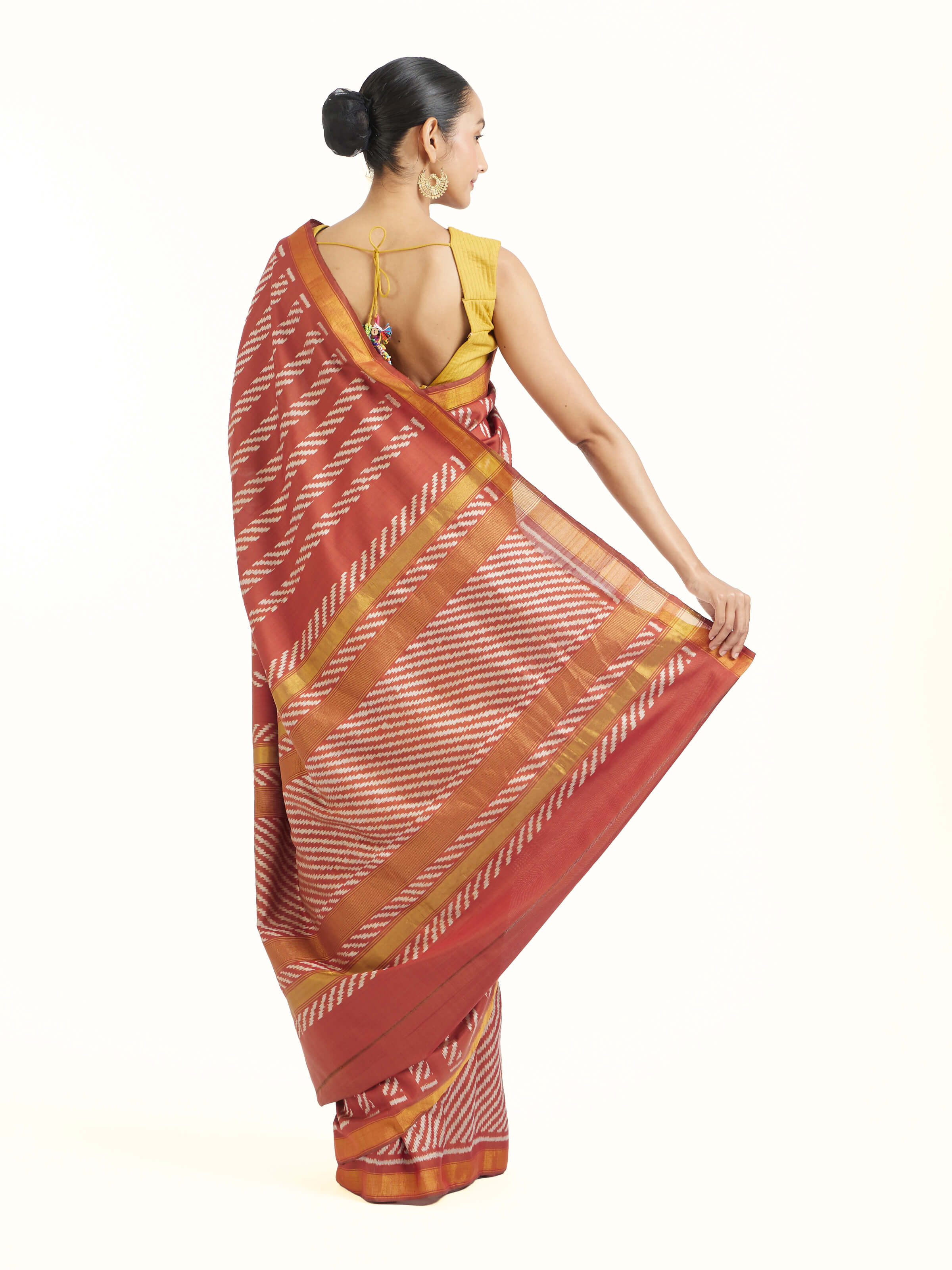 Back view of pink mulberry silk Patola saree displaying patterned pallu