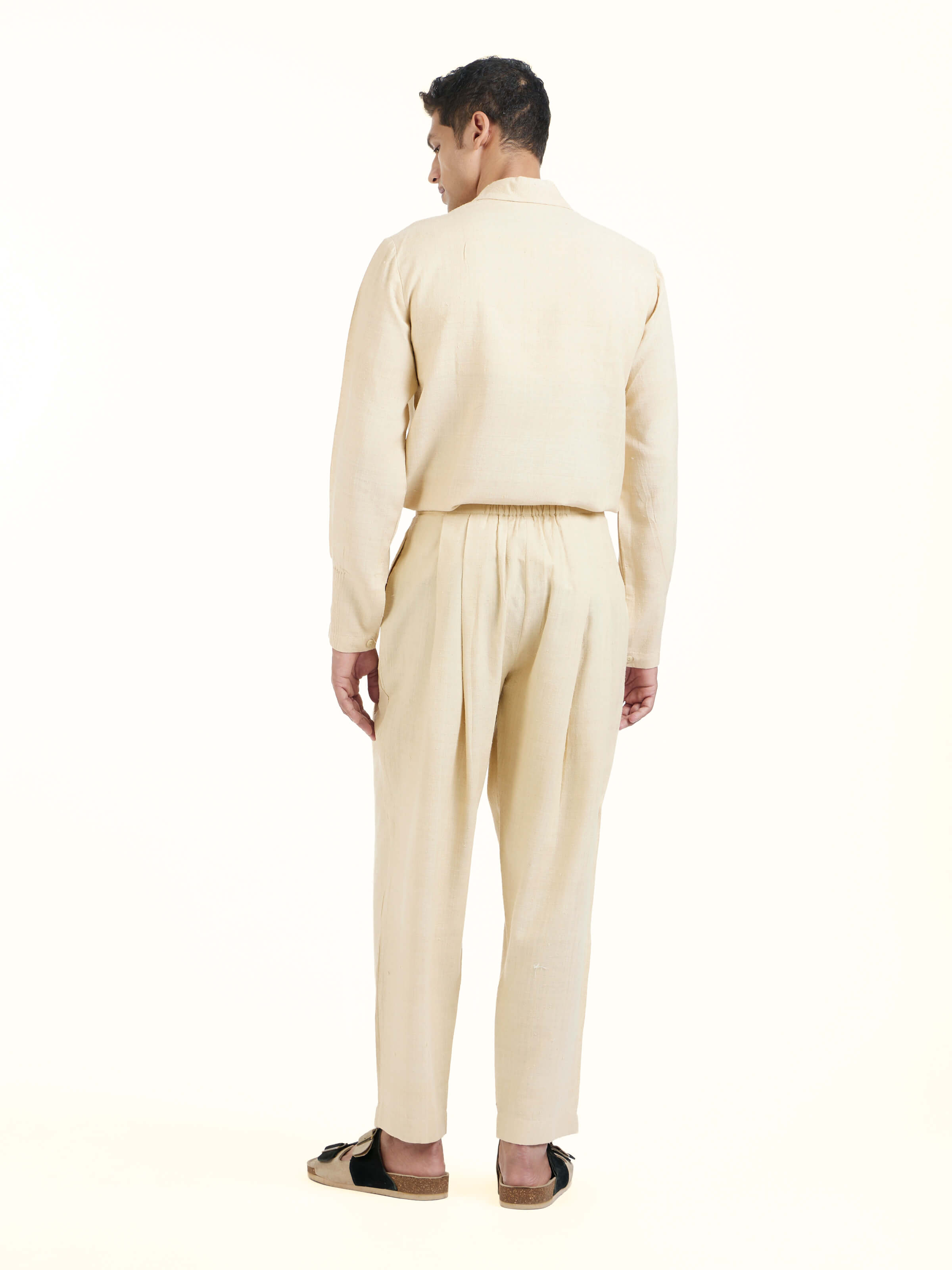 Back view of off-white silk handloom straight pants displaying structured finish