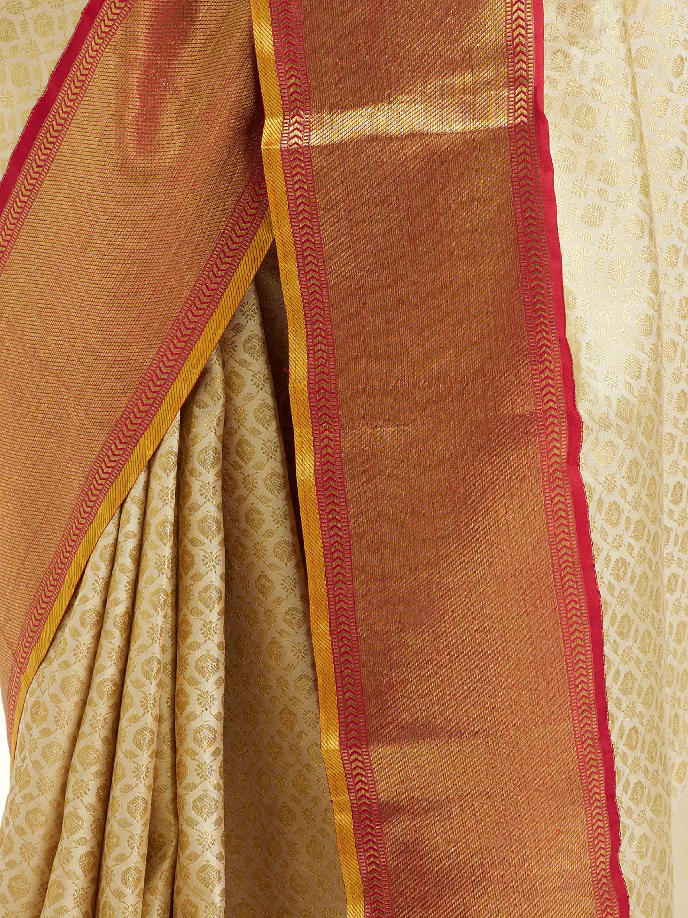 Close-up angled view of peach silk Kancheepuram saree showcasing border and pallu design