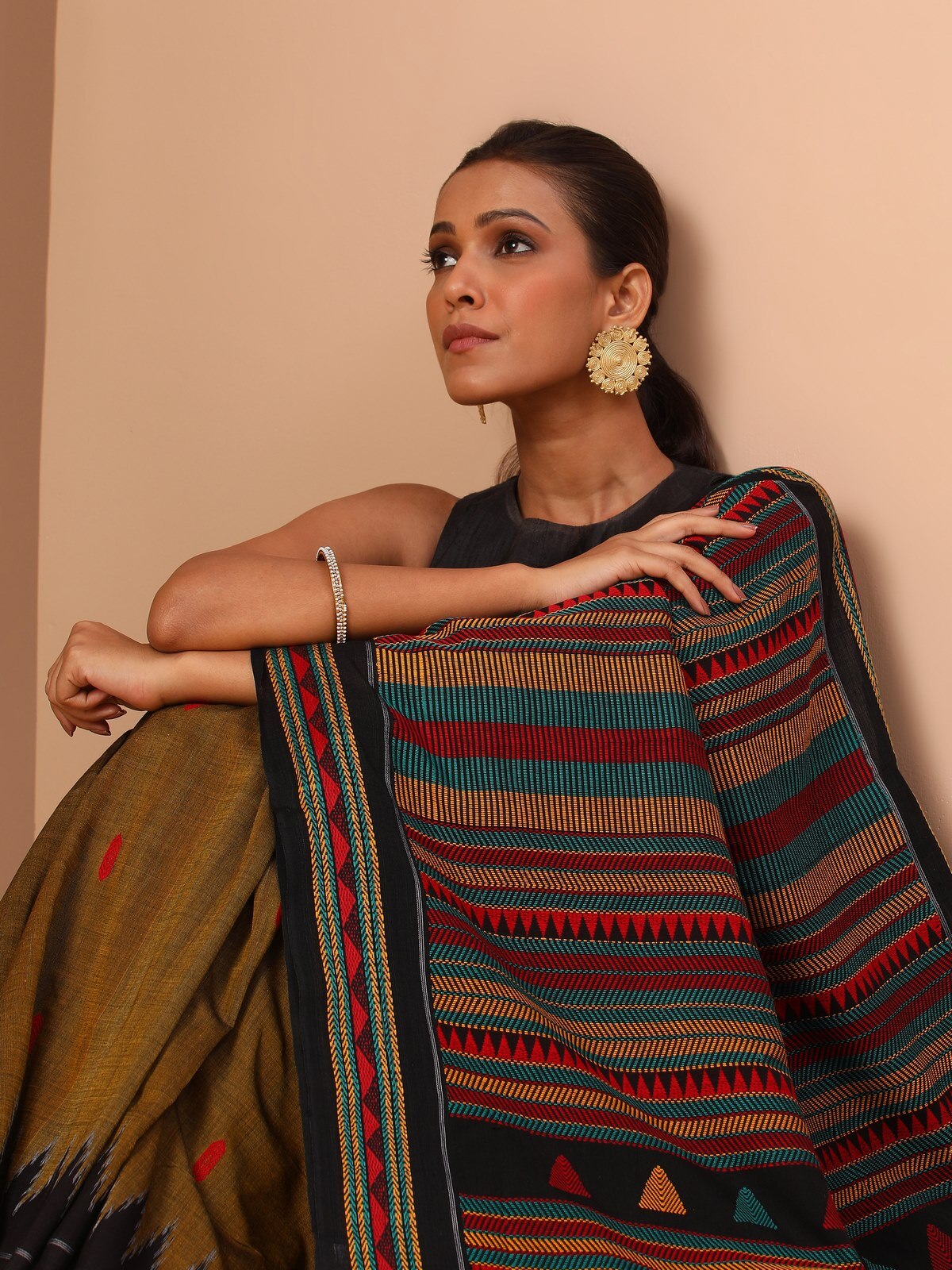 Side view of yellow Dongaria saree showing flowing pleats and border detailing