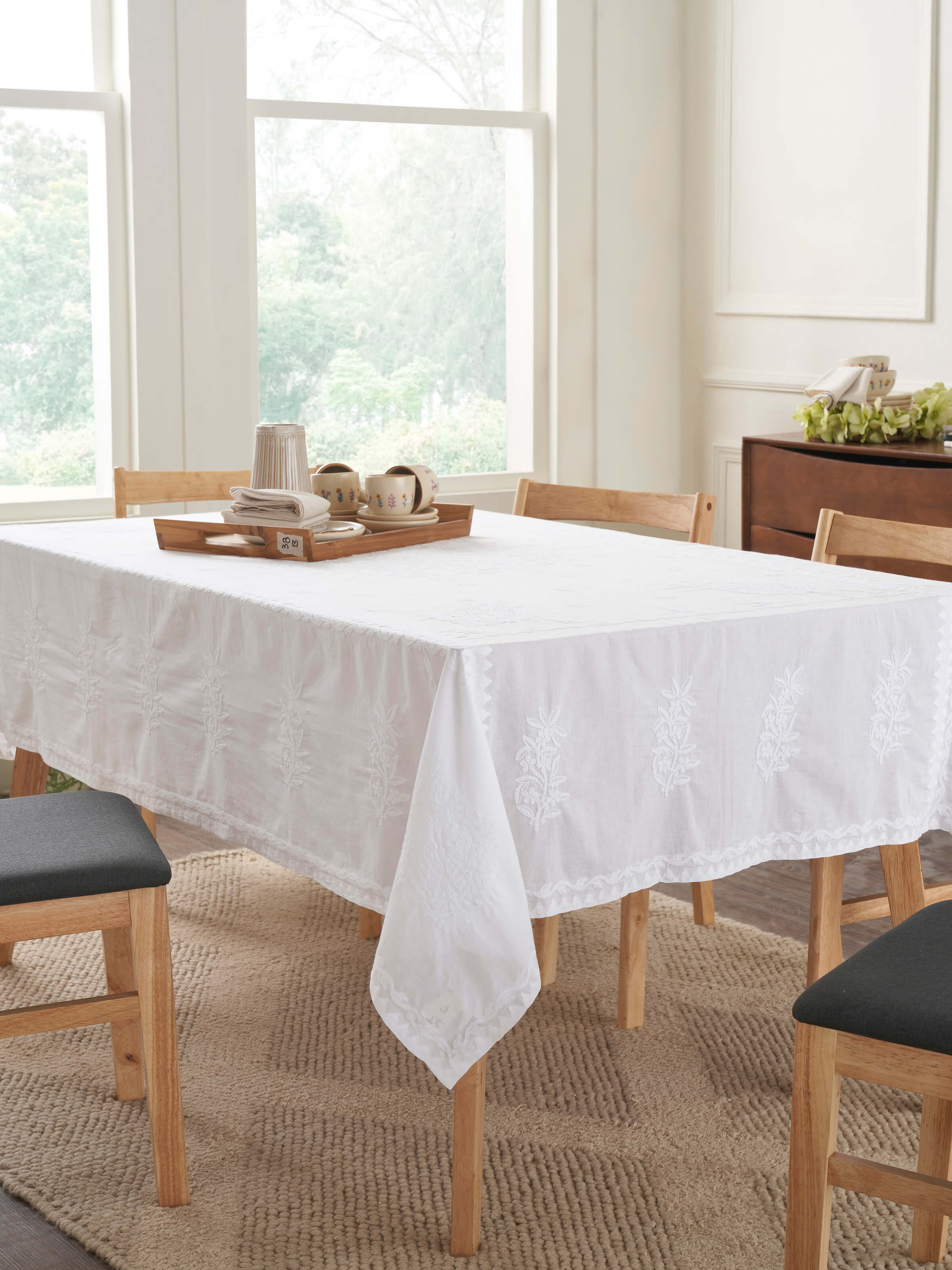 Lifestyle image featuring the table cover laid on a 6-seater dining setup