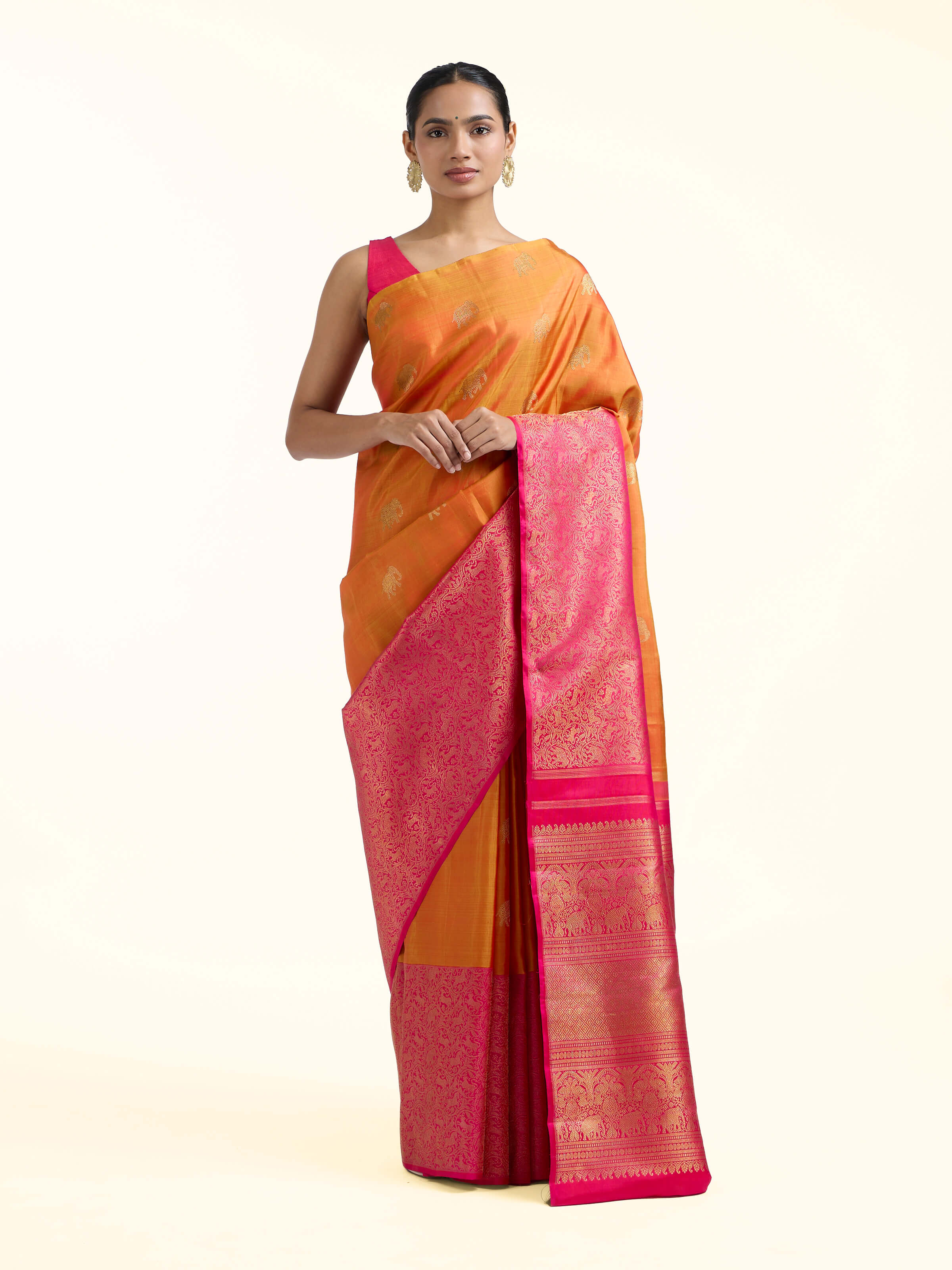 Front view of orange silk Kancheepuram saree with rich zari border