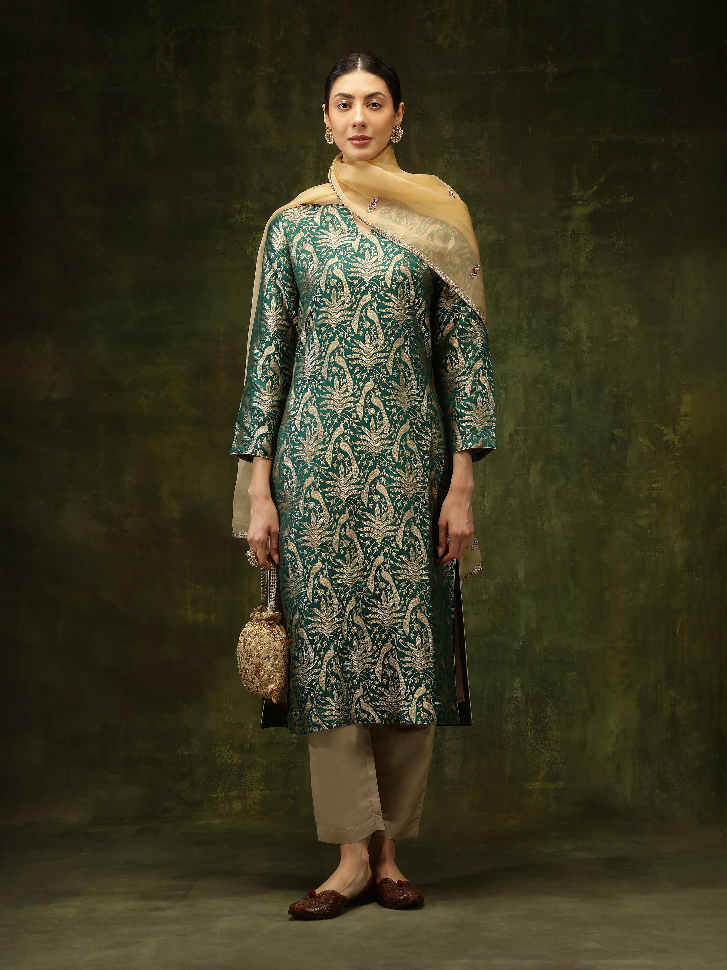 Lifestyle shot of model wearing Green Silk Banarasi Kurta with traditional accessories