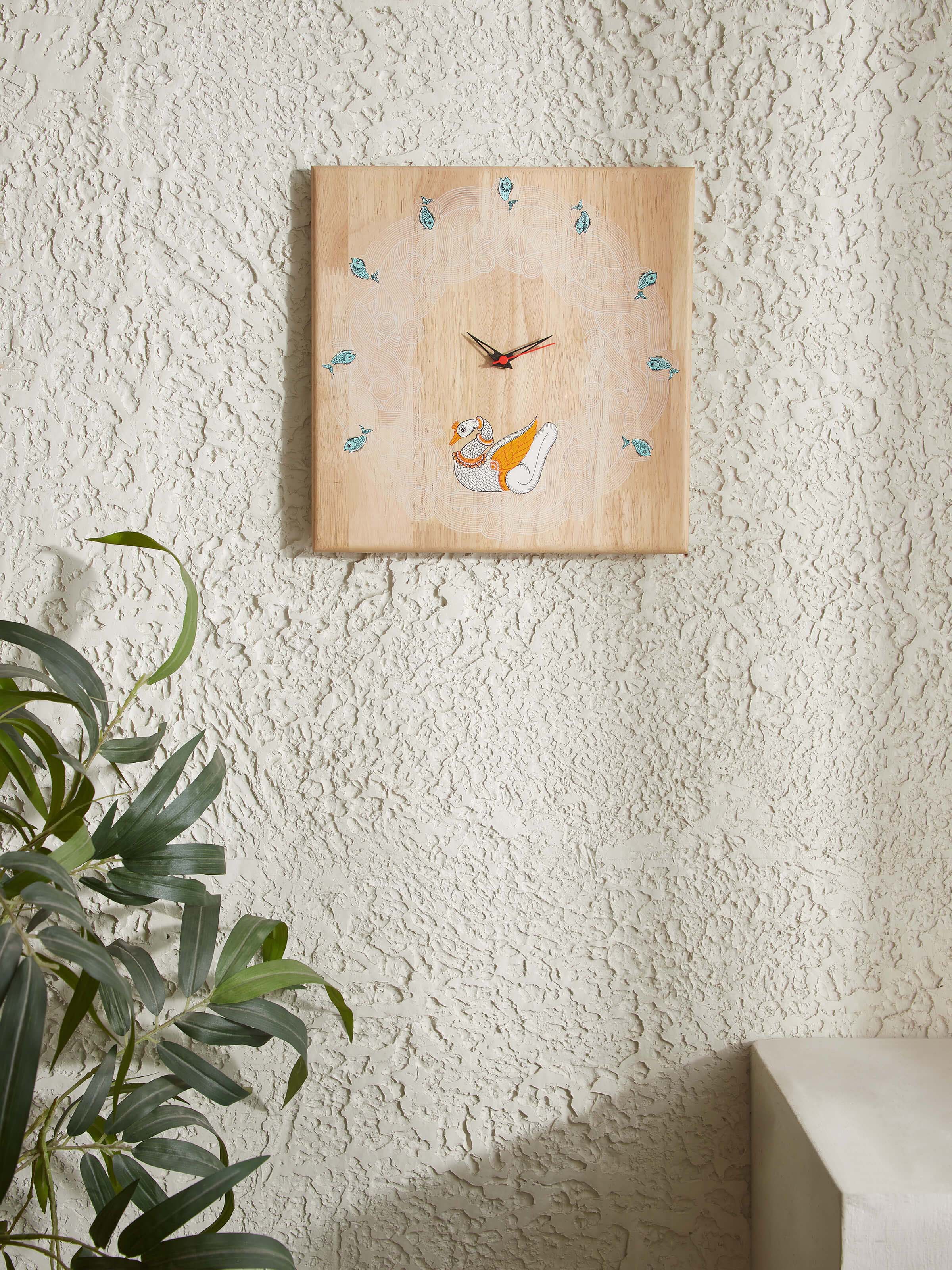 Side view of Transitional Pattachitra Dancing Swan Wooden Wall Clock emphasizing the wooden texture and design.