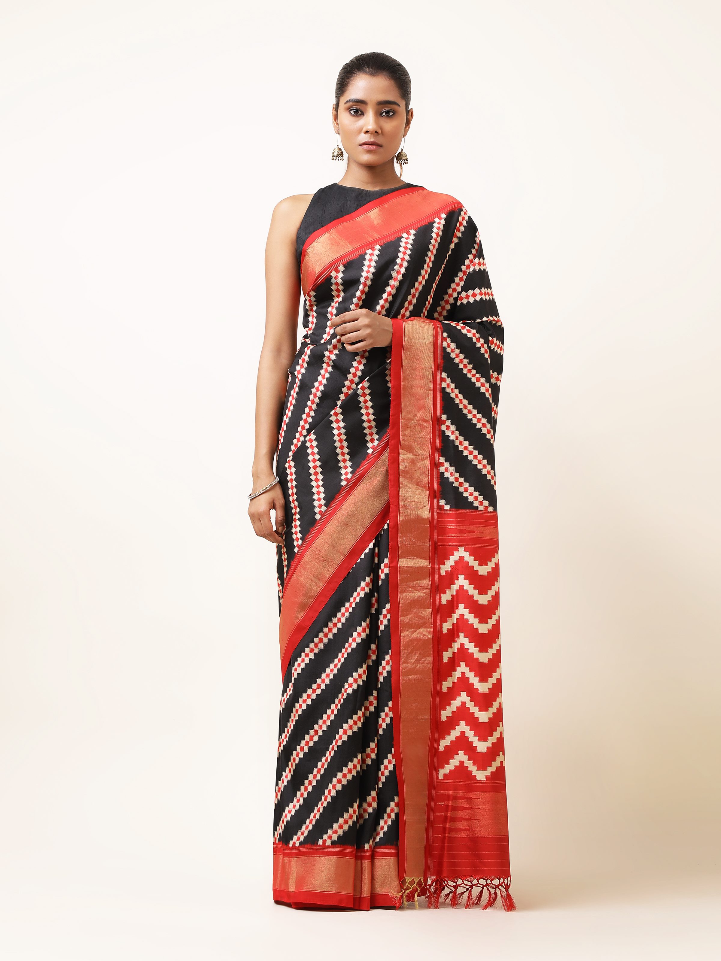 Lifestyle shot of navy blue silk Pochampally saree draped in ethnic style.