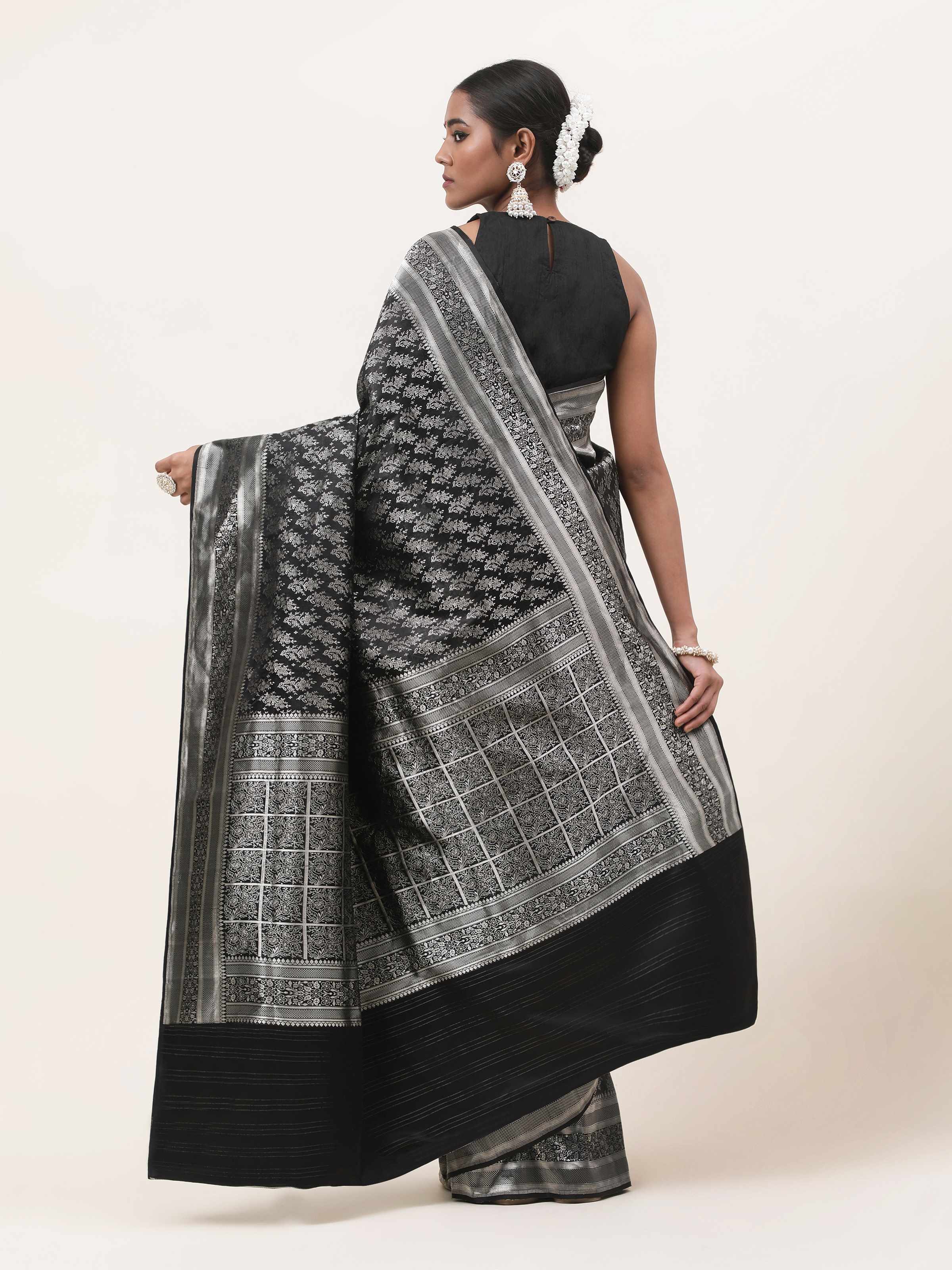 Back view of Black Silk Satin Tanchoi Banarasi Saree highlighting rich fabric and embroidery.