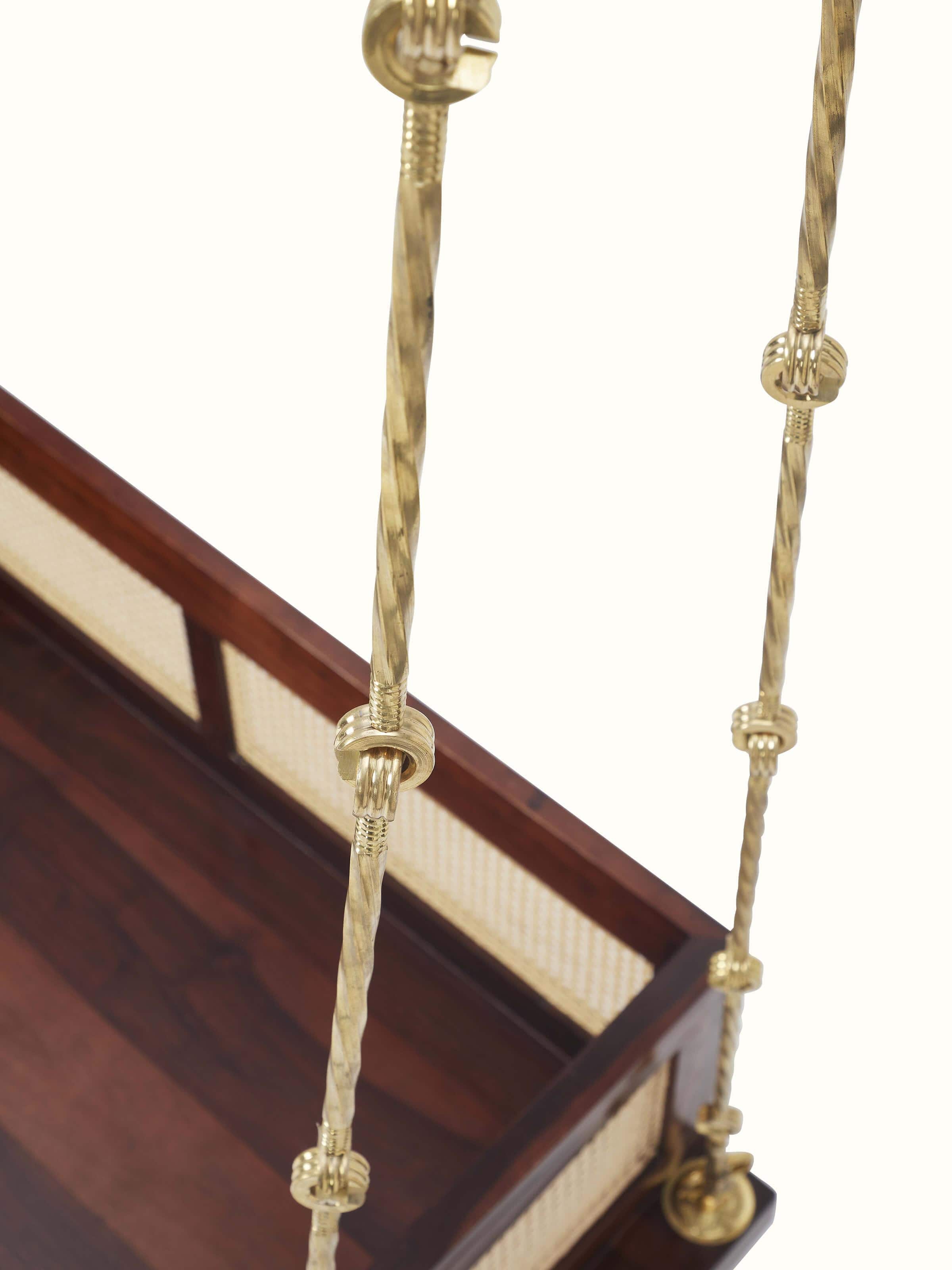 Close-up of the Sheesham wood and cane swing, focusing on the detailed cane weaving and finish of the wood